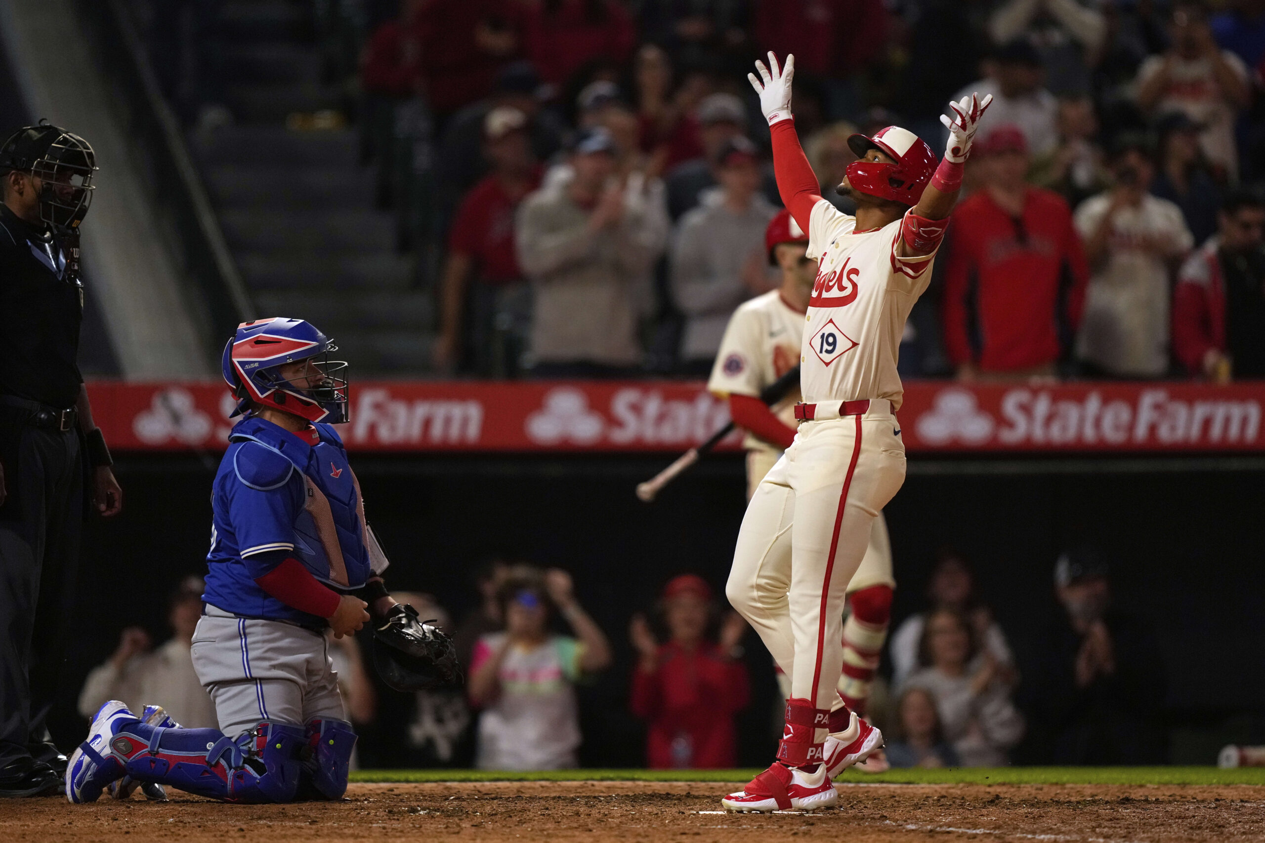 The Angels’ Kyren Paris, right, gestures as he scores after...