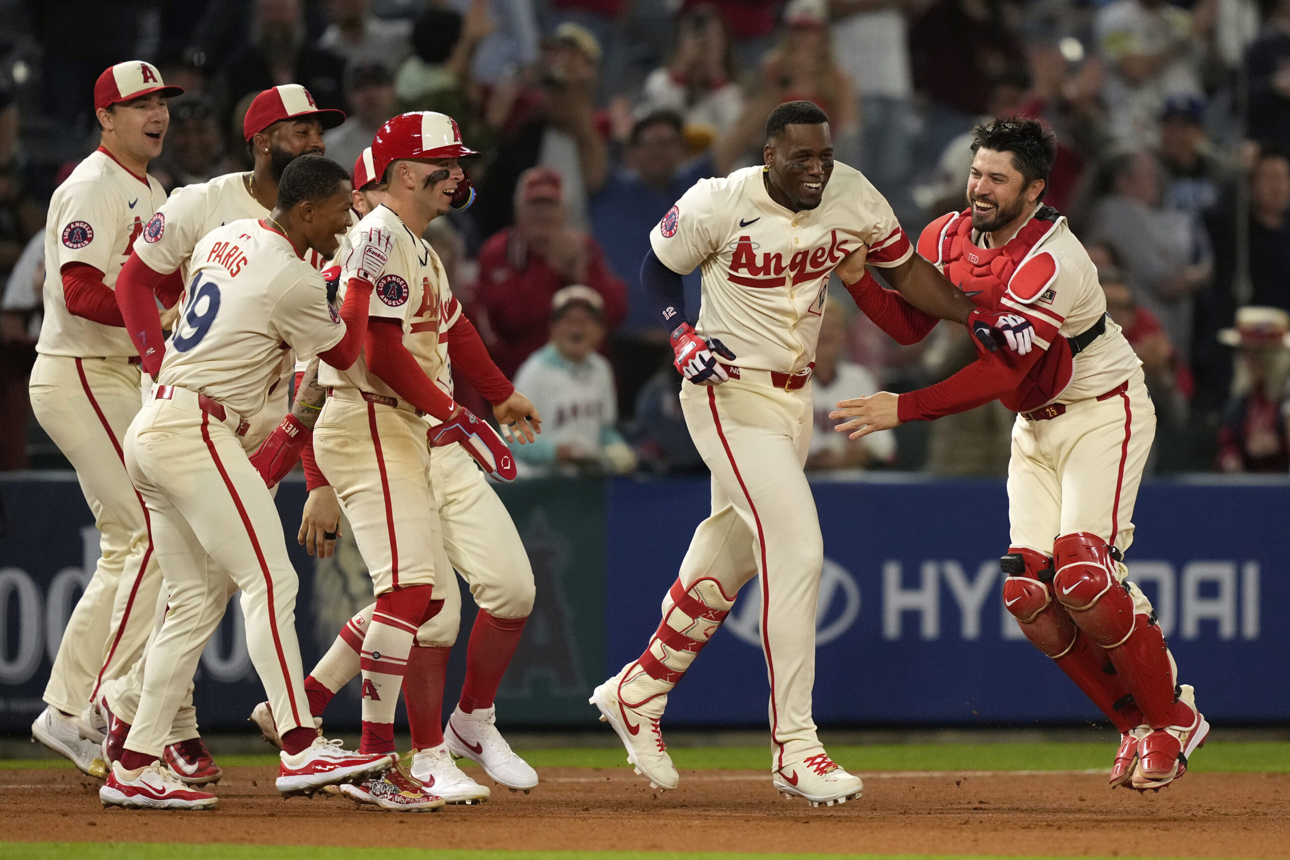 Teammates swarm the Angels’ Jorge Soler, second from right, after...
