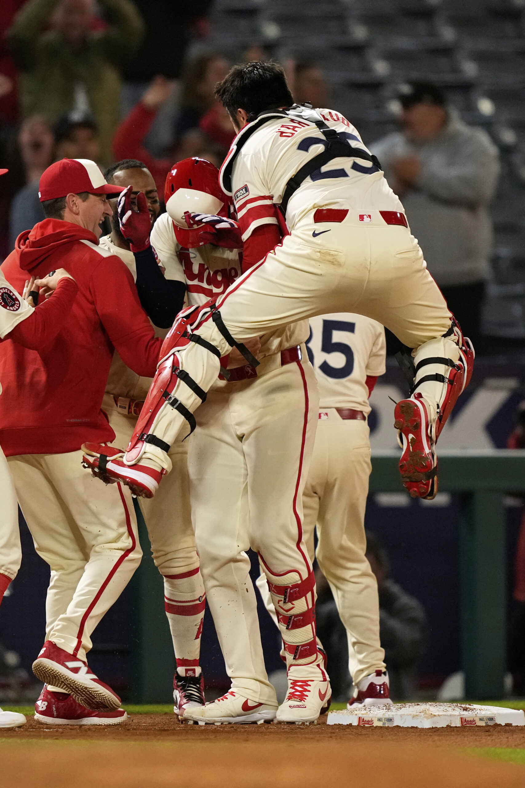 Teammates swarm the Angels’ Jorge Soler, second from right, after...