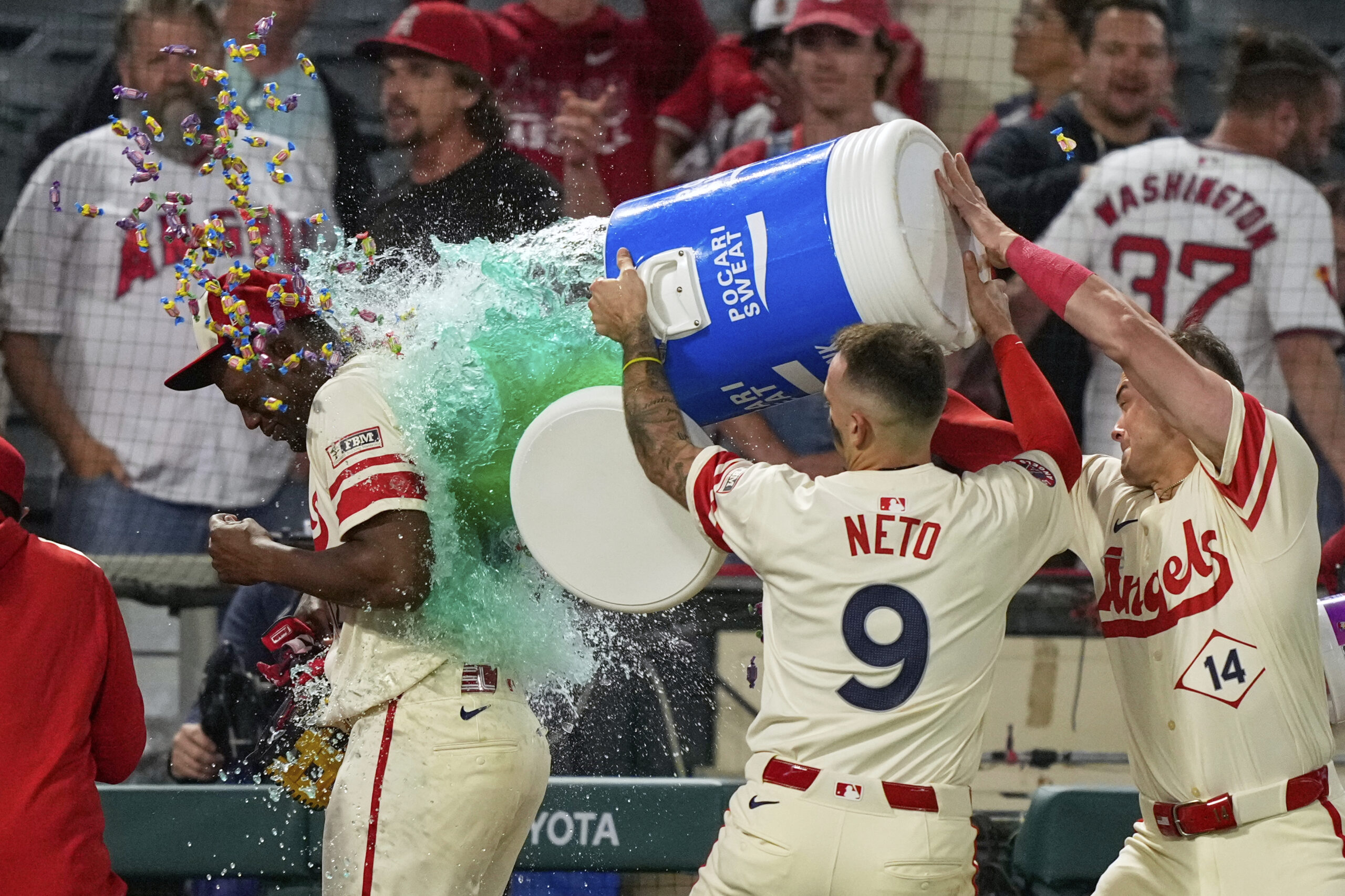 The Angels’ Jorge Soler, left, has a bucket of sports...