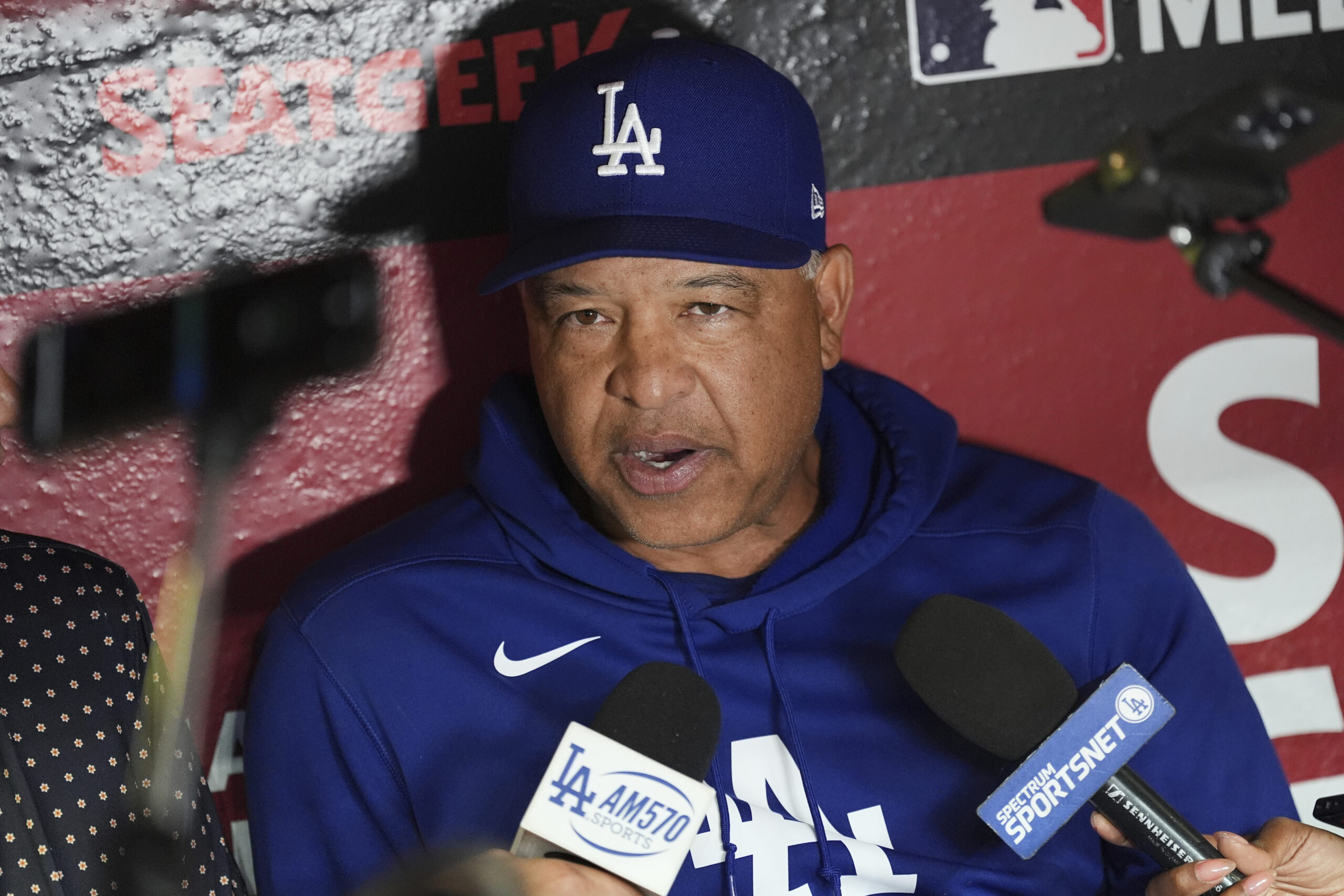 Dodgers manager Dave Roberts answers a question from reporters in...