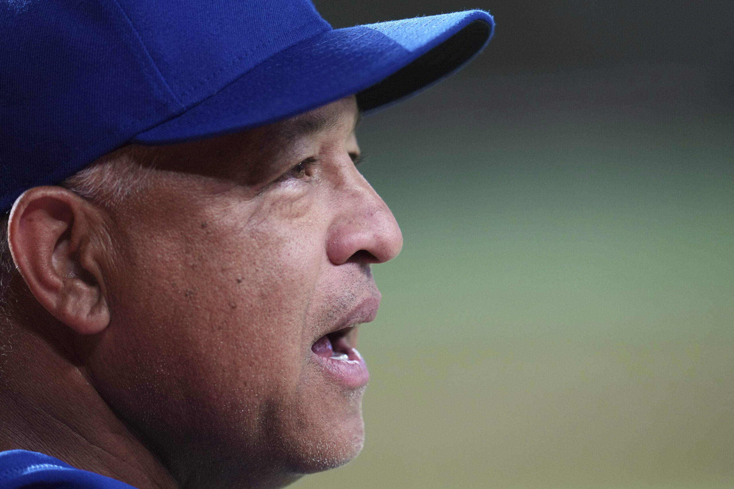 Dodgers manager Dave Roberts talks on the field prior to...
