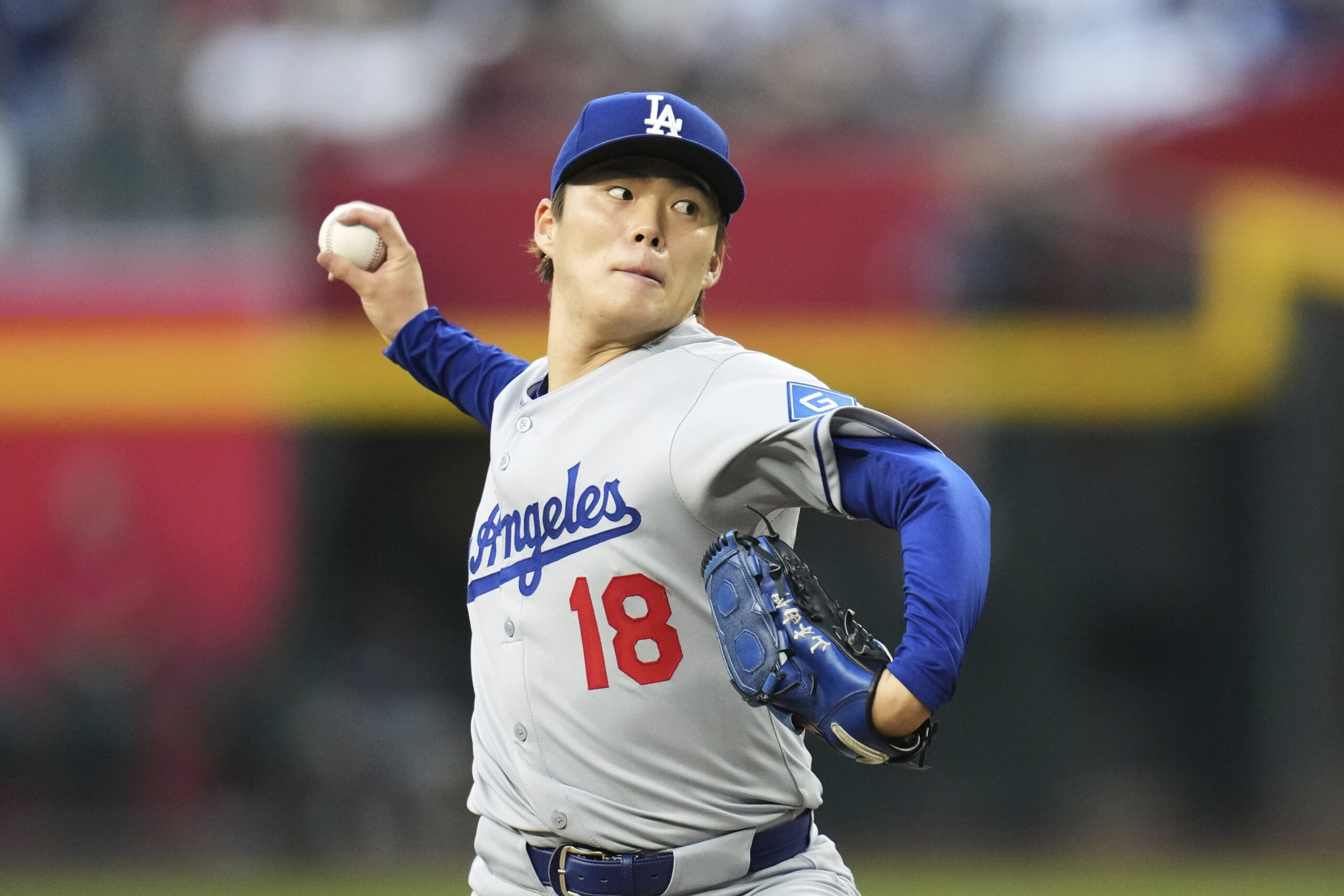 Dodgers starting pitcher Yoshinobu Yamamoto throws to the plate during...