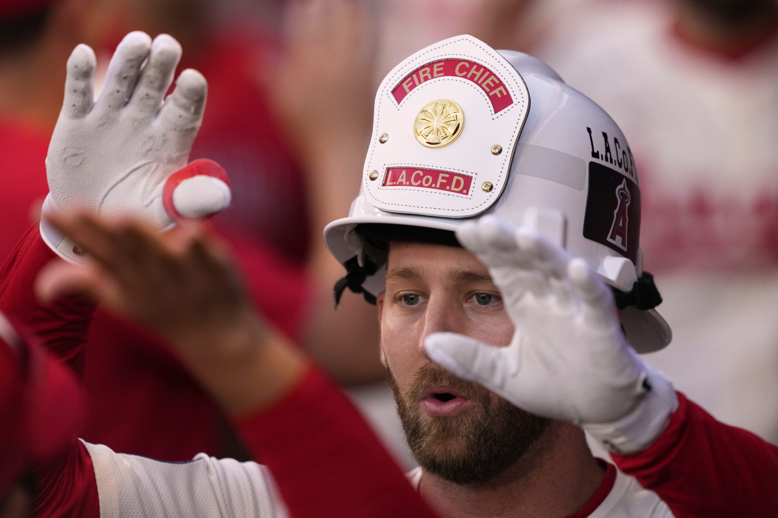 The Angels’ Taylor Ward is congratulated by teammates in the...