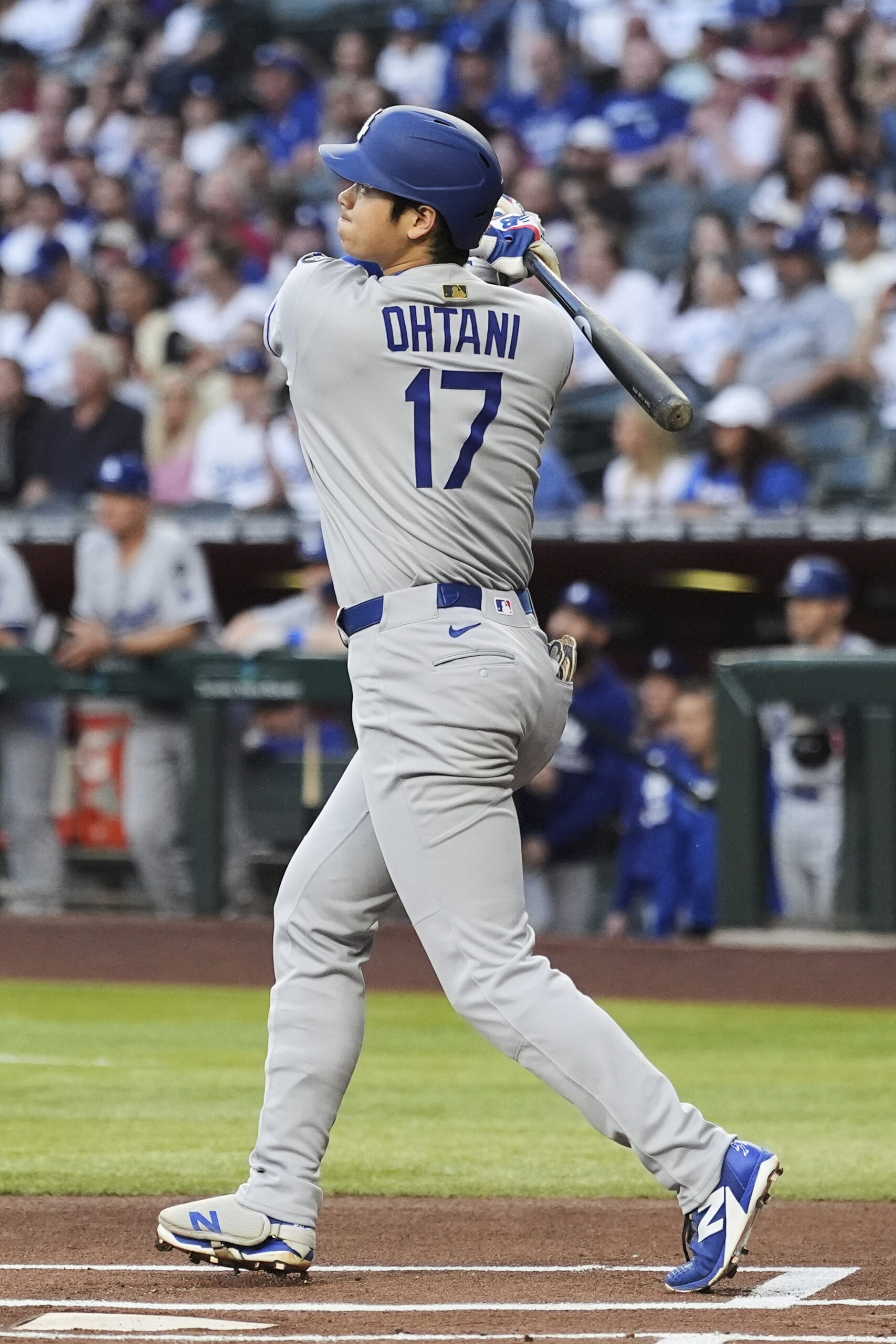 Dodgers designated hitter Shohei Ohtani watches the flight of his...