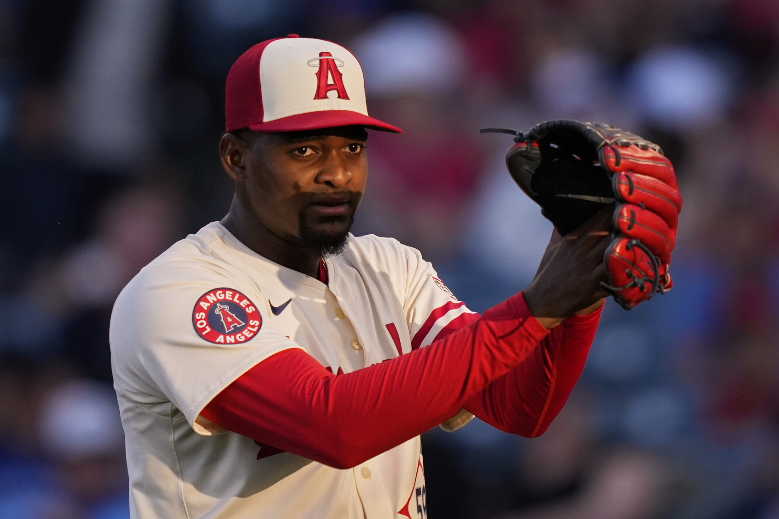 Angels starting pitcher Jose Soriano claps after striking out the...