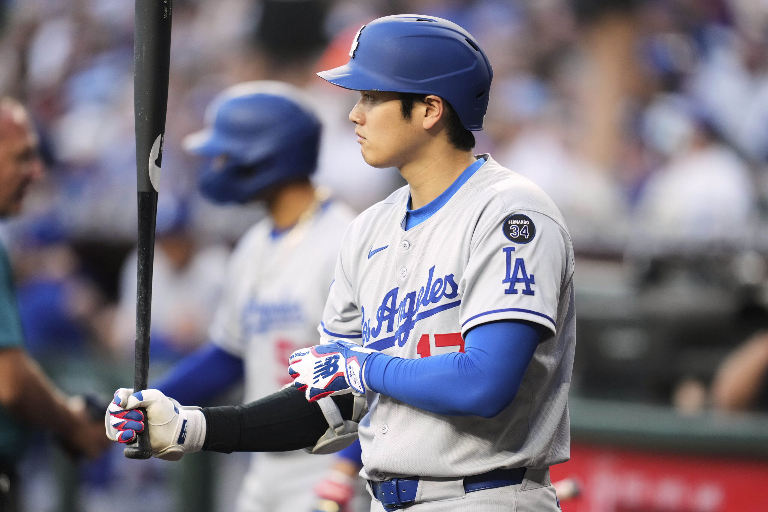 Dodgers star Shohei Ohtani waits to bat before the first...