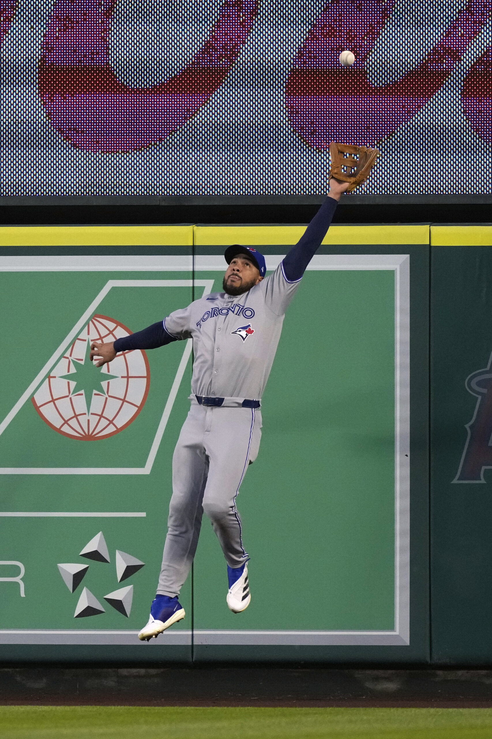 Toronto Blue Jays right fielder Anthony Santander leaps to catch...