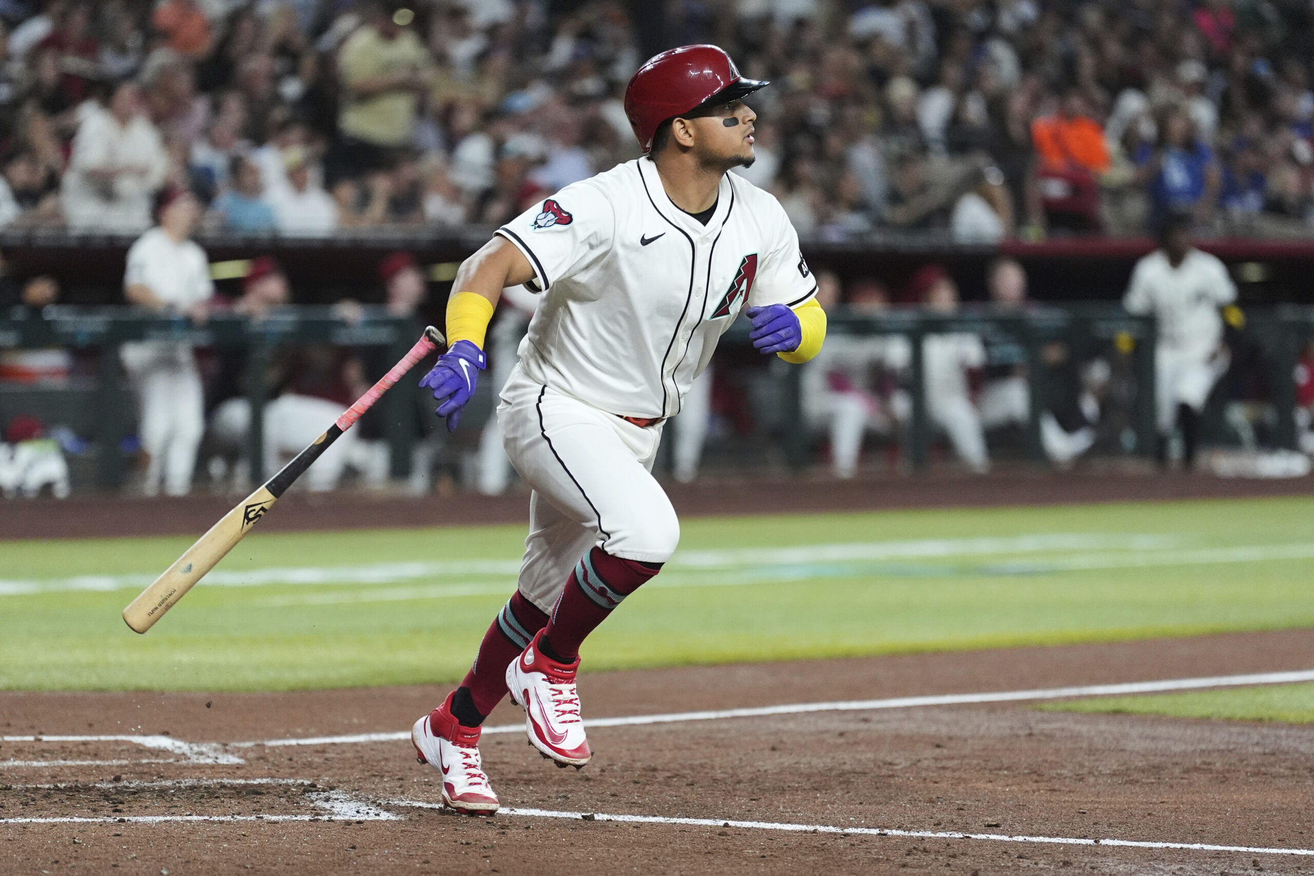 The Arizona Diamondbacks’ Gabriel Moreno watches the flight of his...