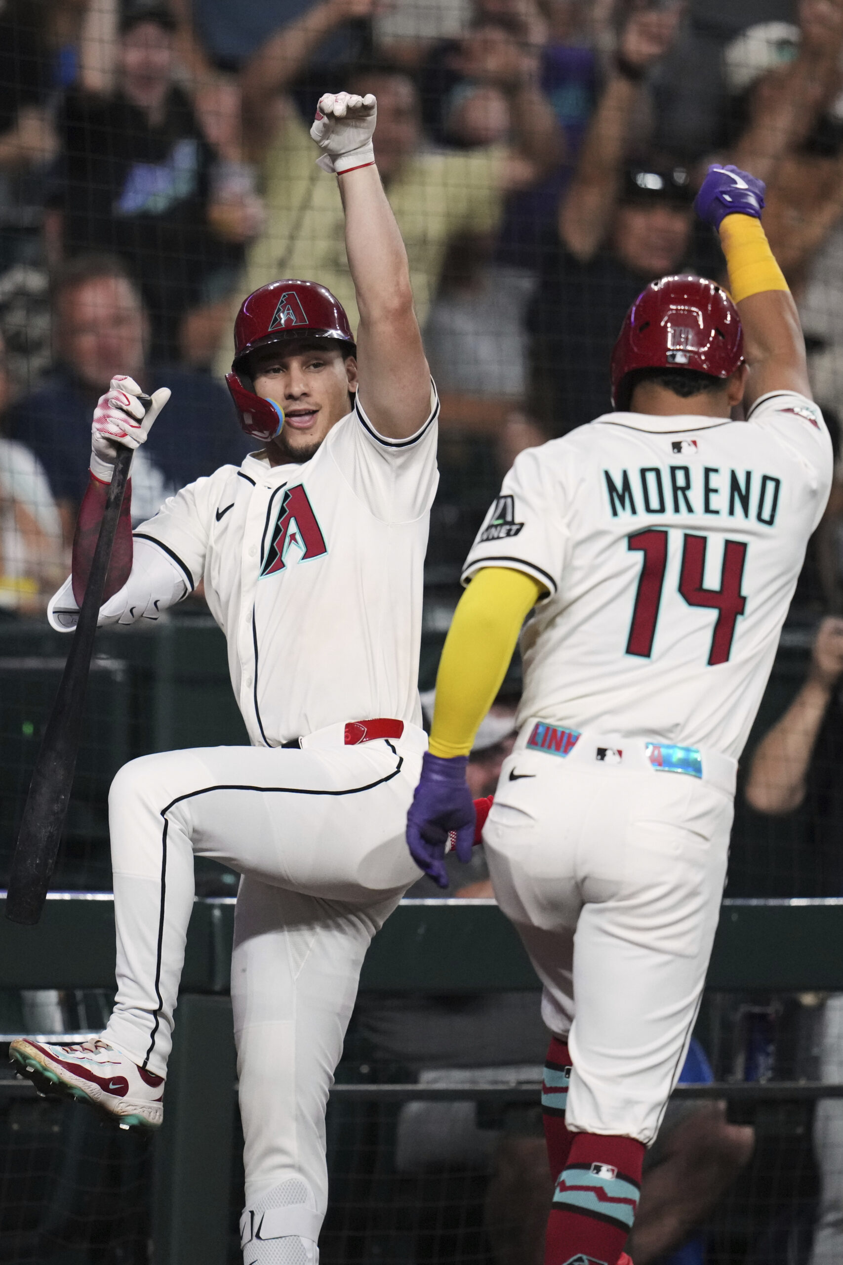 The Arizona Diamondbacks’ Gabriel Moreno, right, celebrates with teammate Alek...