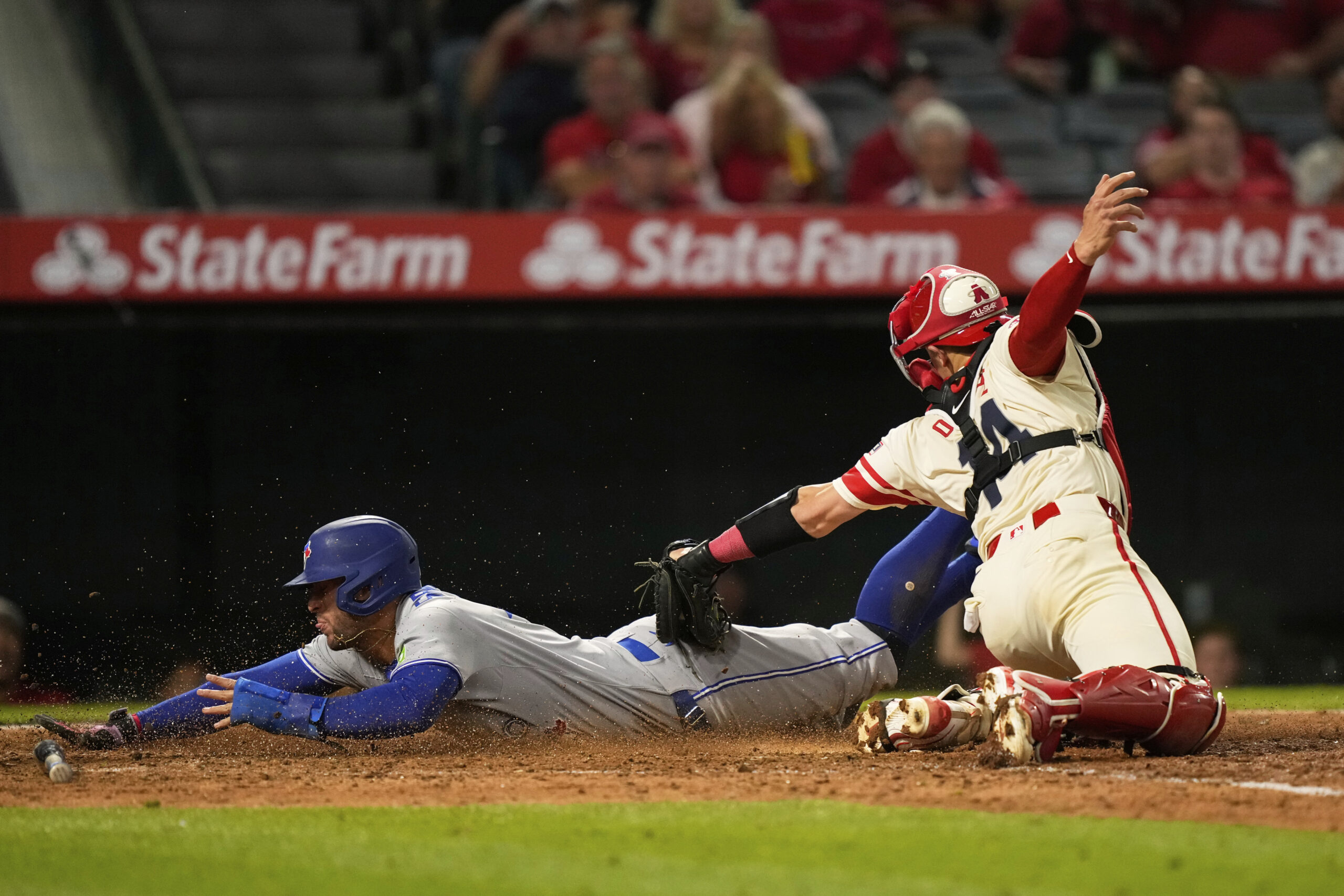 The Toronto Blue Jays’ George Springer, left, scores under the...
