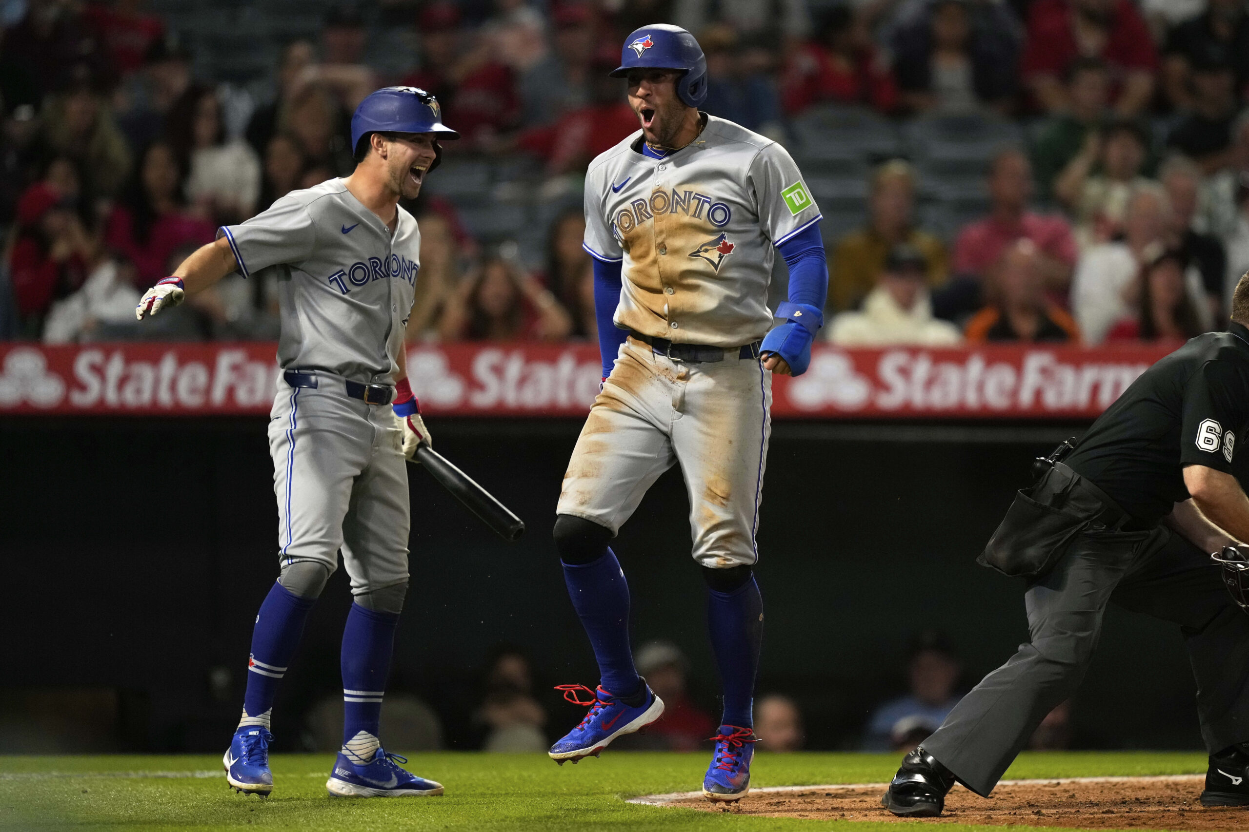 The Toronto Blue Jays’ George Springer, right, celebrates with Ernie...