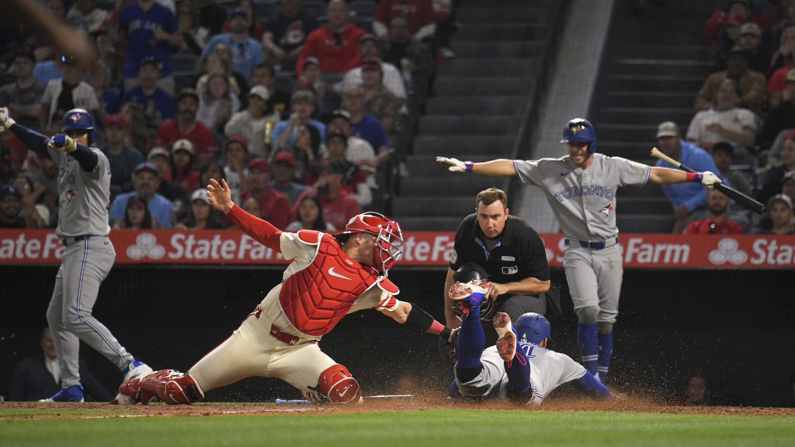 Toronto Blue Jays’ George Springer, second from right, scores under...