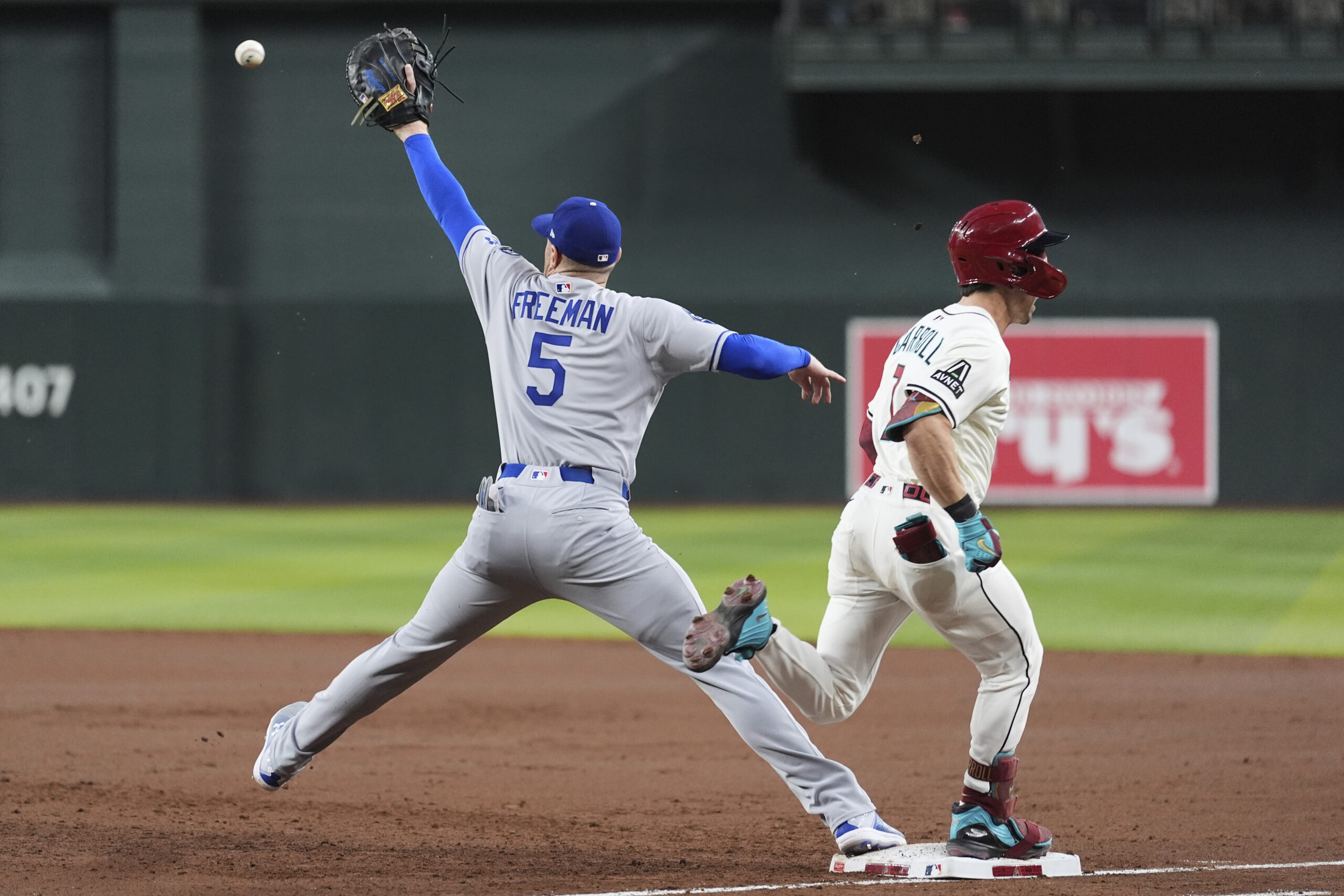 Dodgers first baseman Freddie Freeman reaches to make a late...