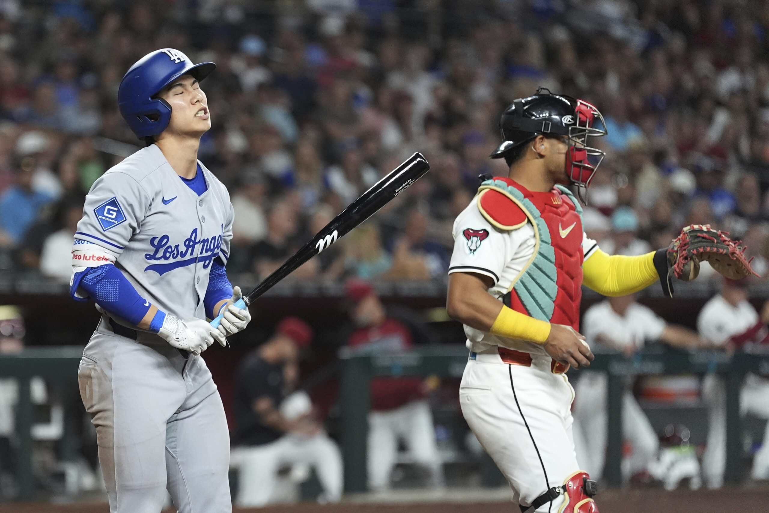 The Dodgers’ Hyeseong Kim, left, reacts to striking out as...
