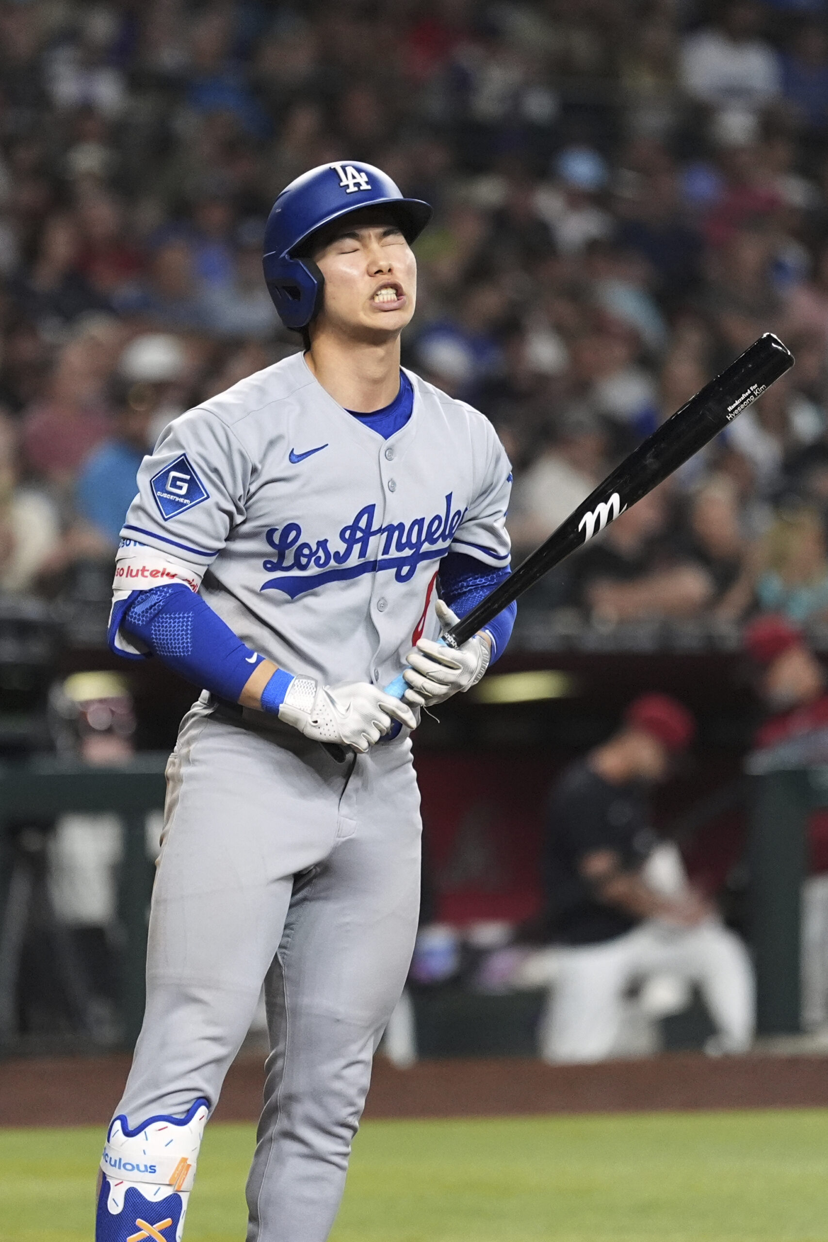The Dodgers’ Hyeseong Kim, left, reacts to striking out during...