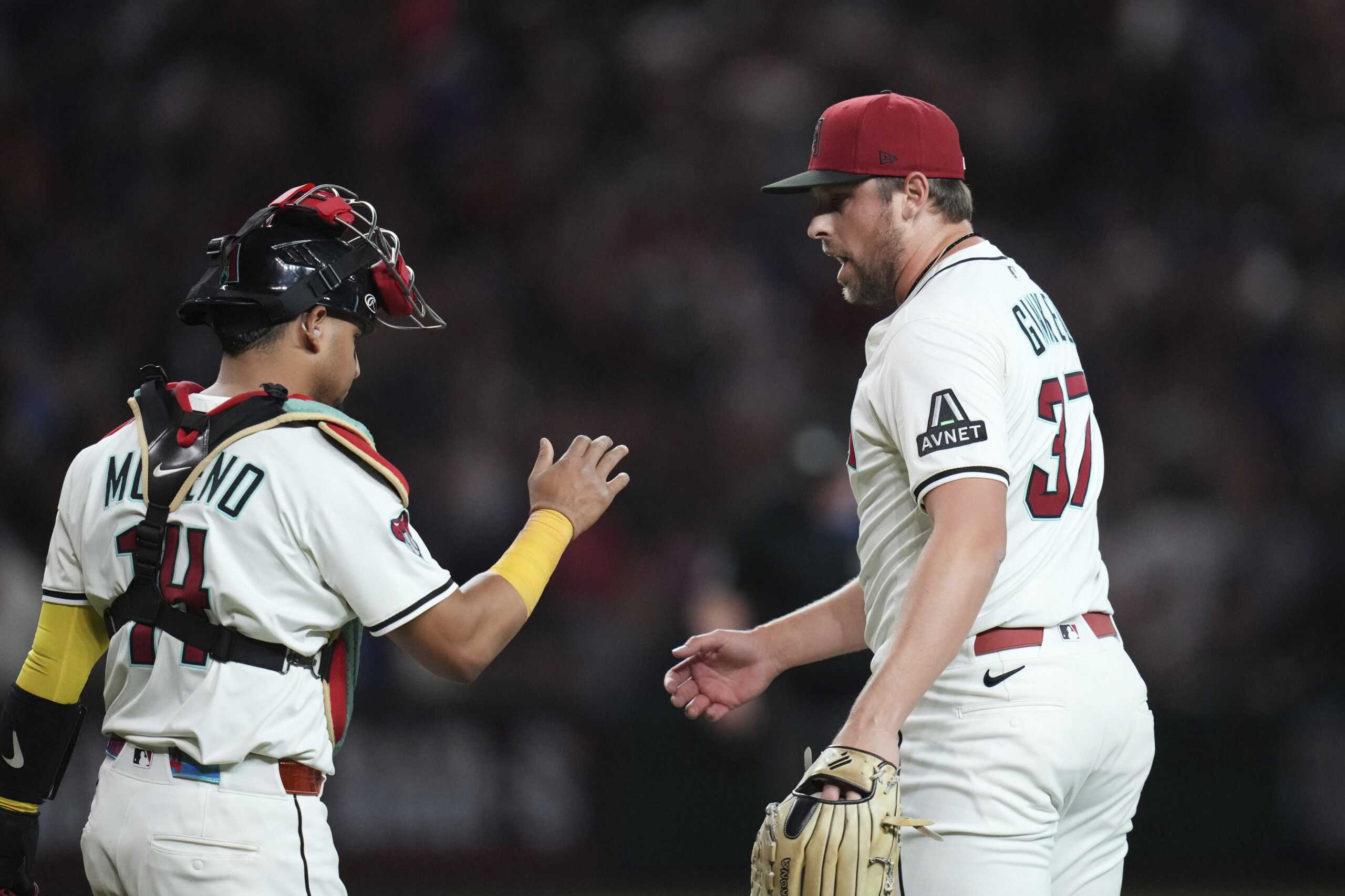 Arizona Diamondbacks relief pitcher Kevin Ginkel, right, celebrates with catcher...