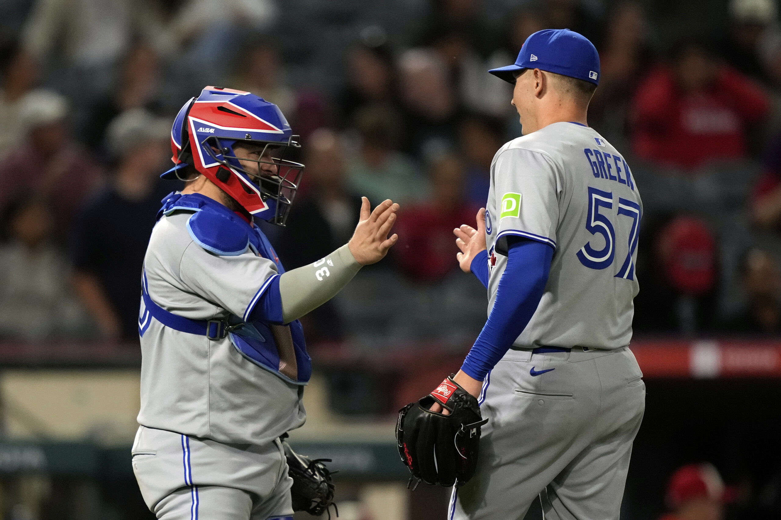 Toronto Blue Jays catcher Alejandro Kirk, left, and relief pitcher...