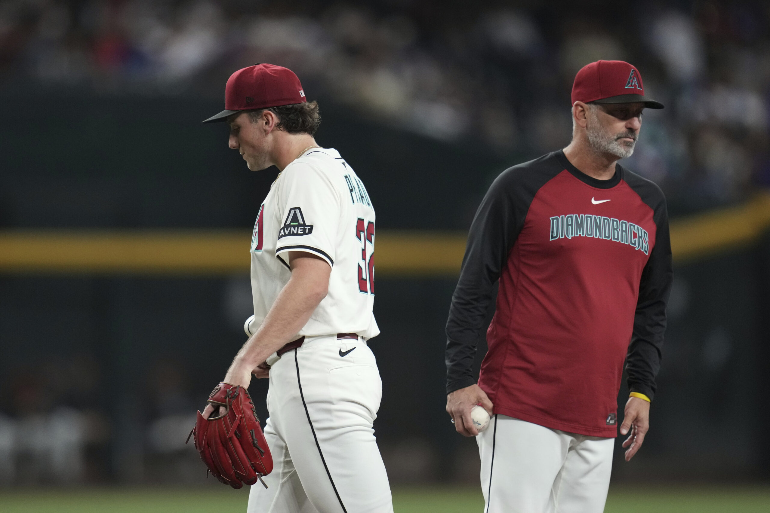 Arizona Diamondbacks manager Torey Lovullo, right, takes the ball from...