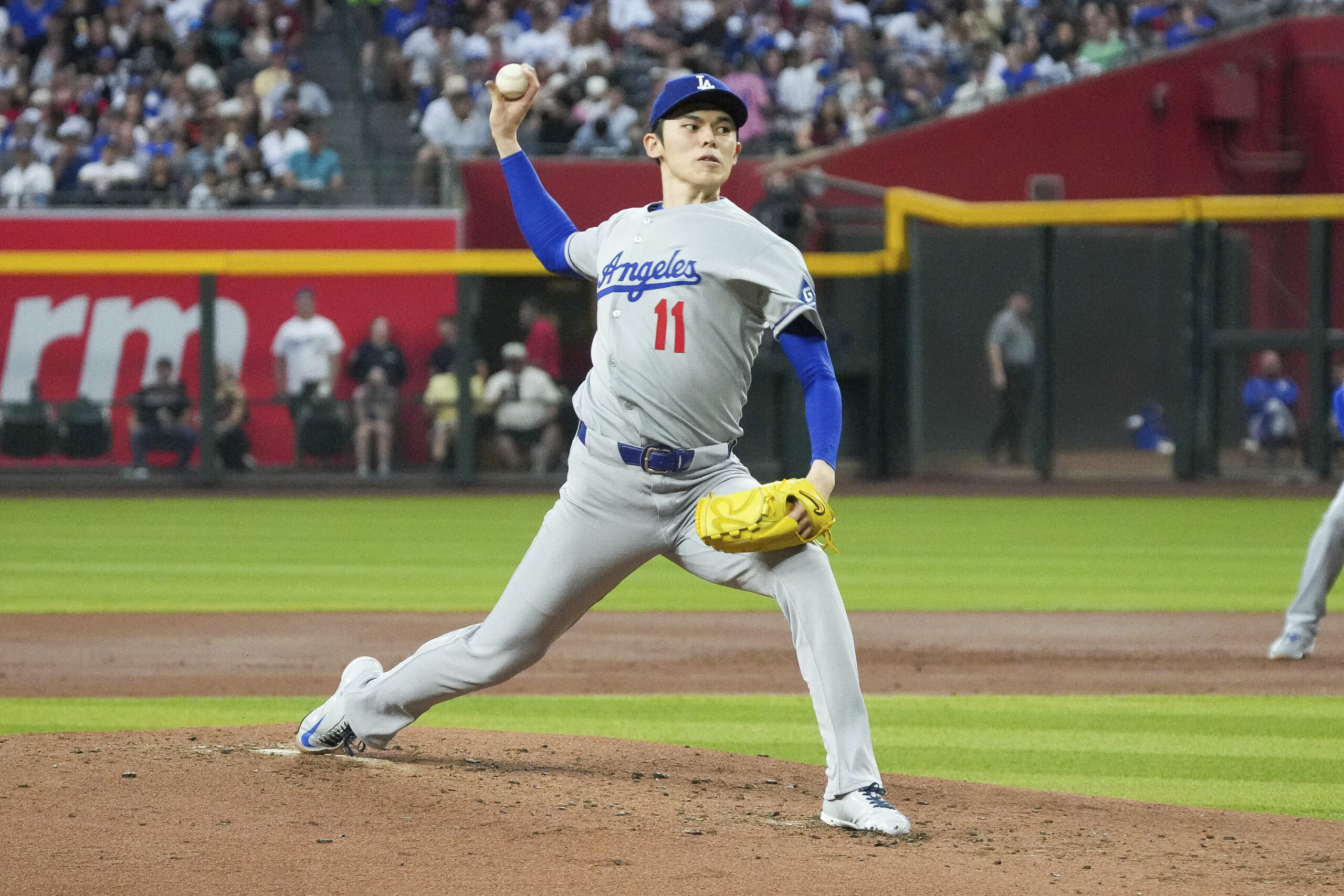 Dodgers starting pitcher Roki Sasaki throws to the plate during...