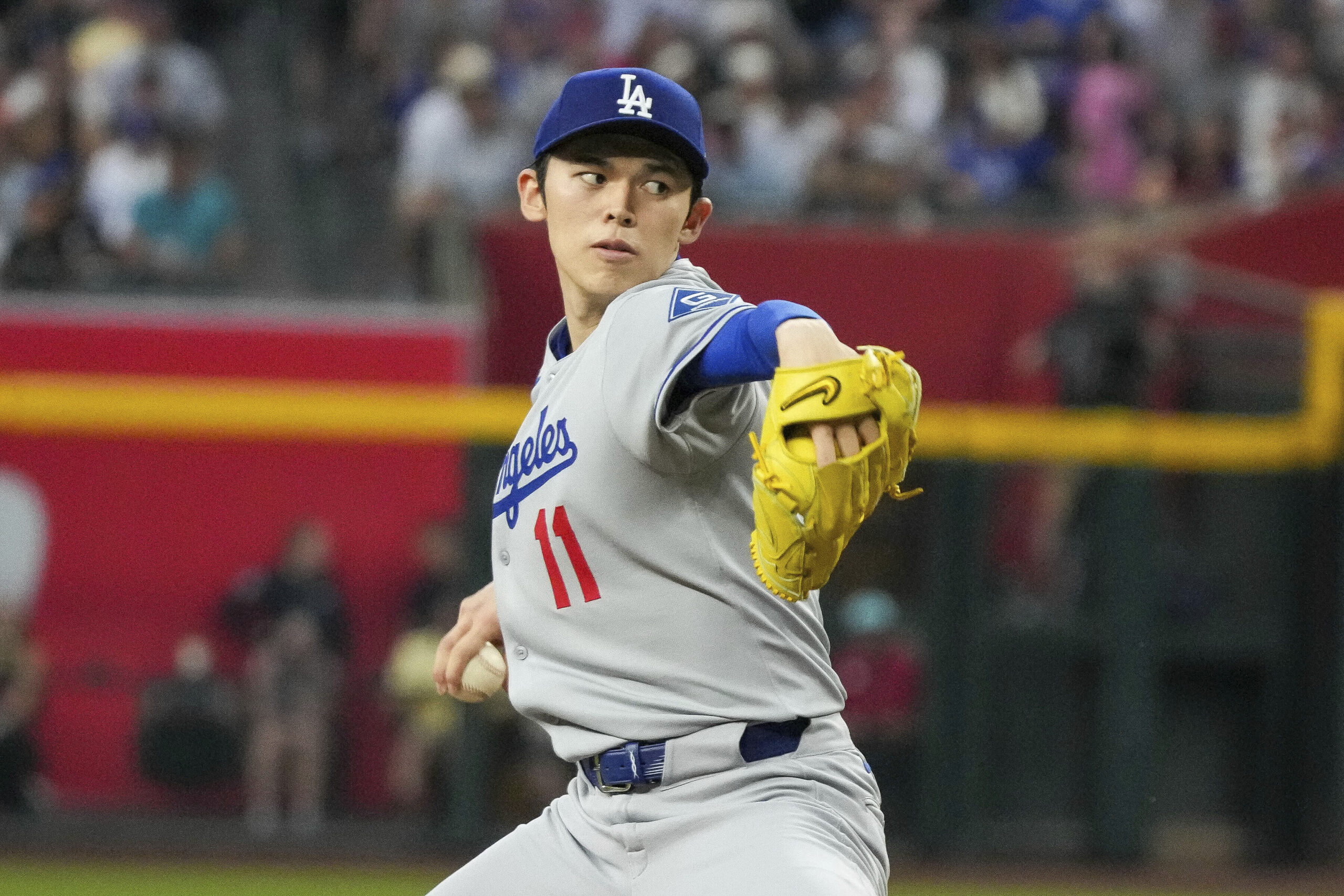 Dodgers pitcher Roki Sasaki throws to the plate against the...