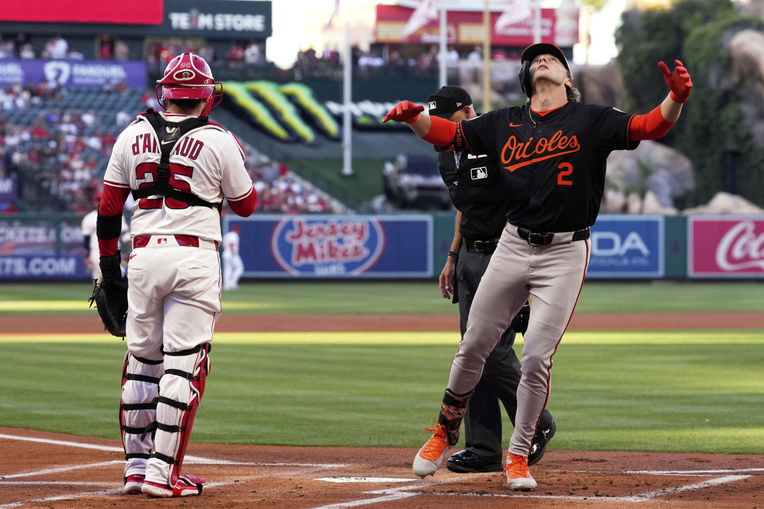 The Baltimore Orioles’ Gunnar Henderson, right, gestures as he scores...