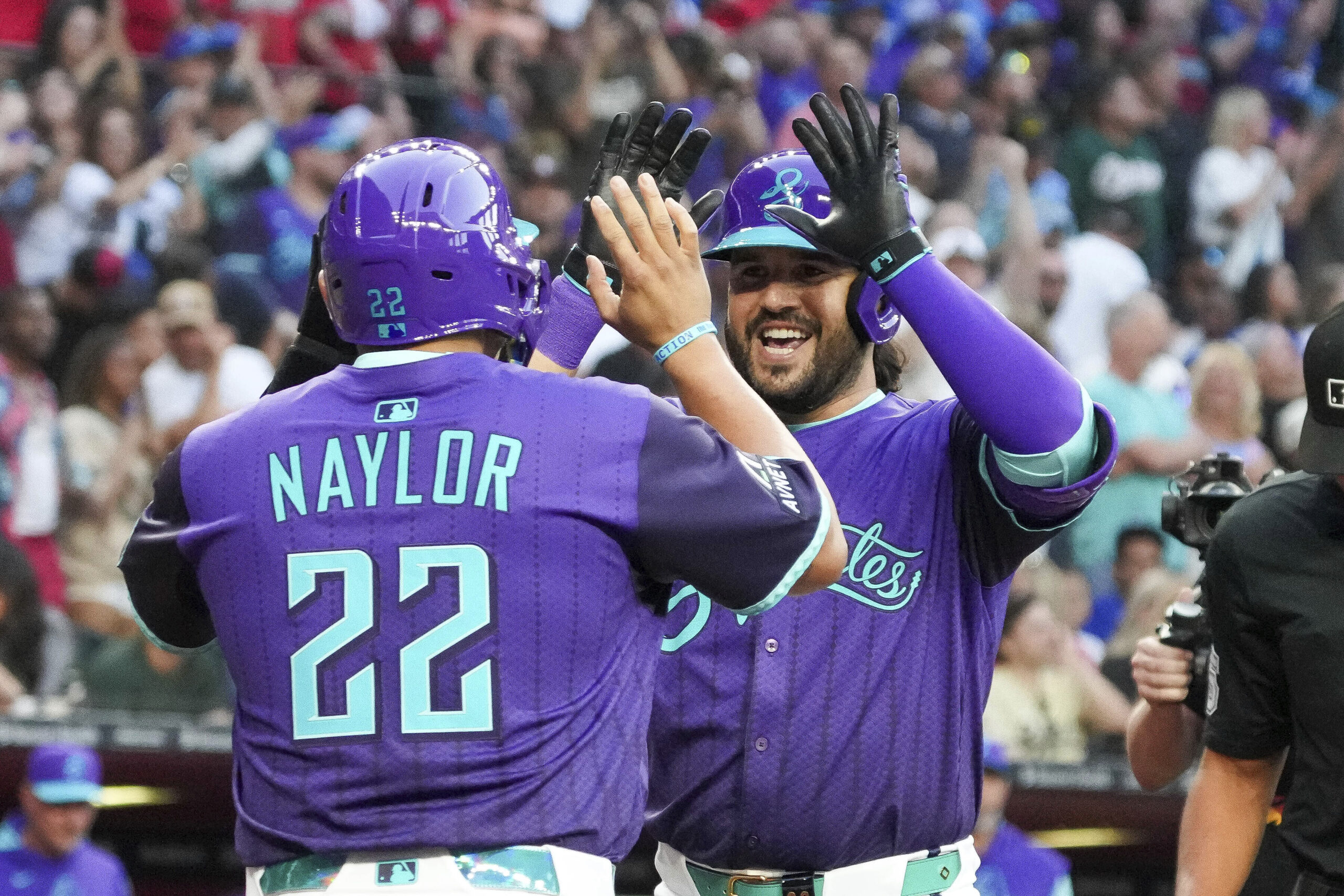 The Arizona Diamondbacks’ Eugenio Suárez, right, is greeted by Josh...