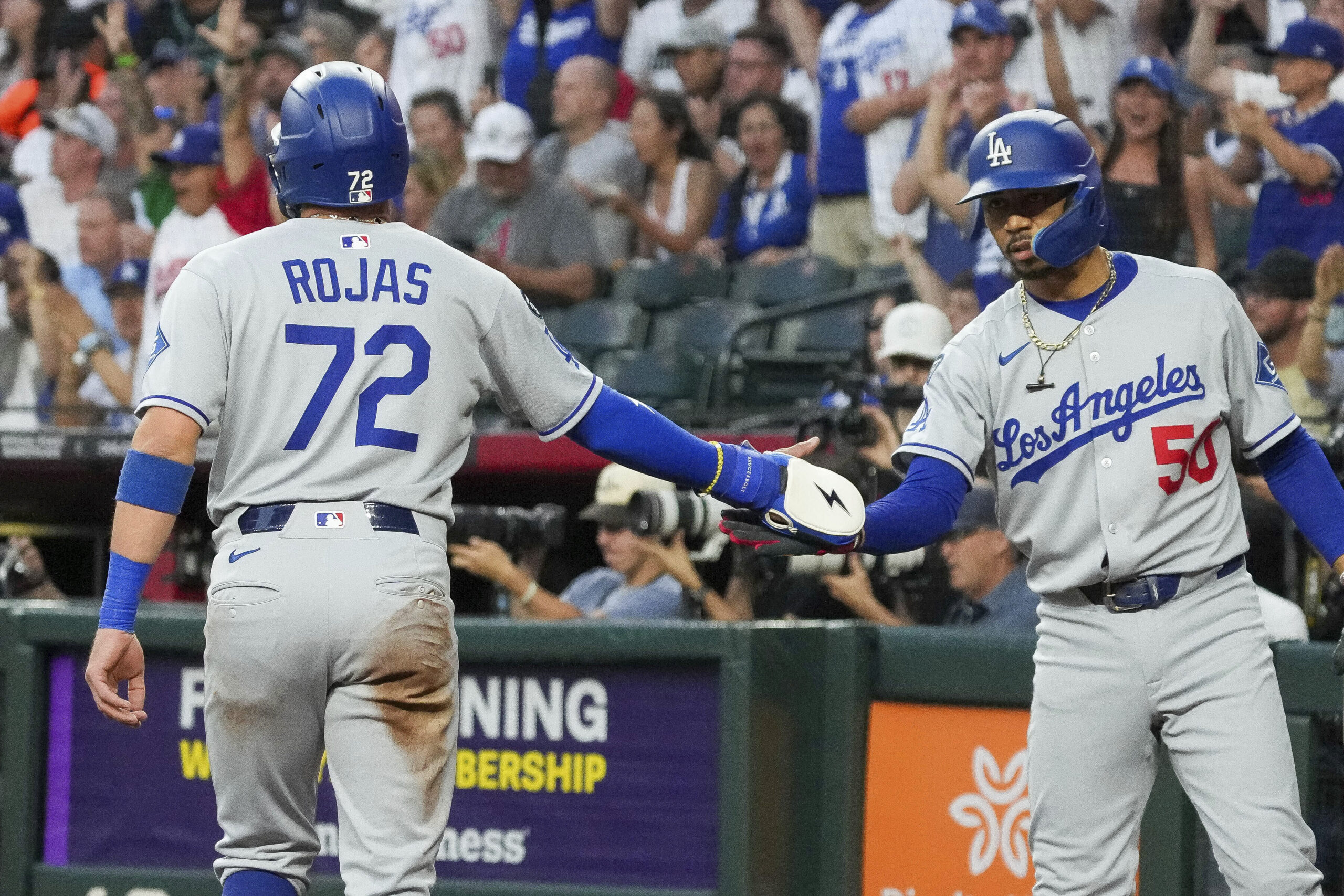 The Dodgers’ Mookie Betts, right, slaps hands with Miguel Rojas,...