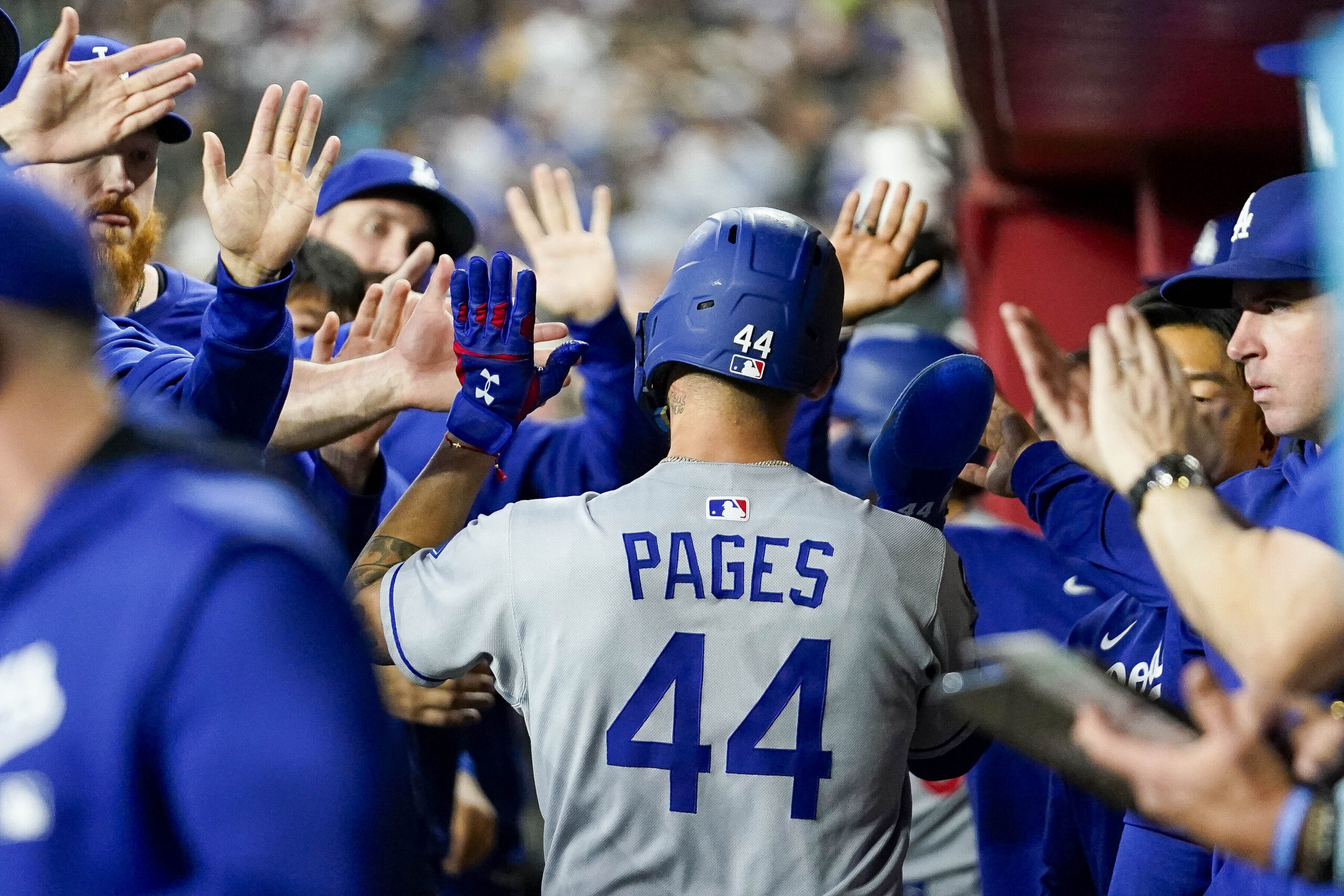 The Dodgers’ Andy Pages (44) gets high-fives from teammates after...
