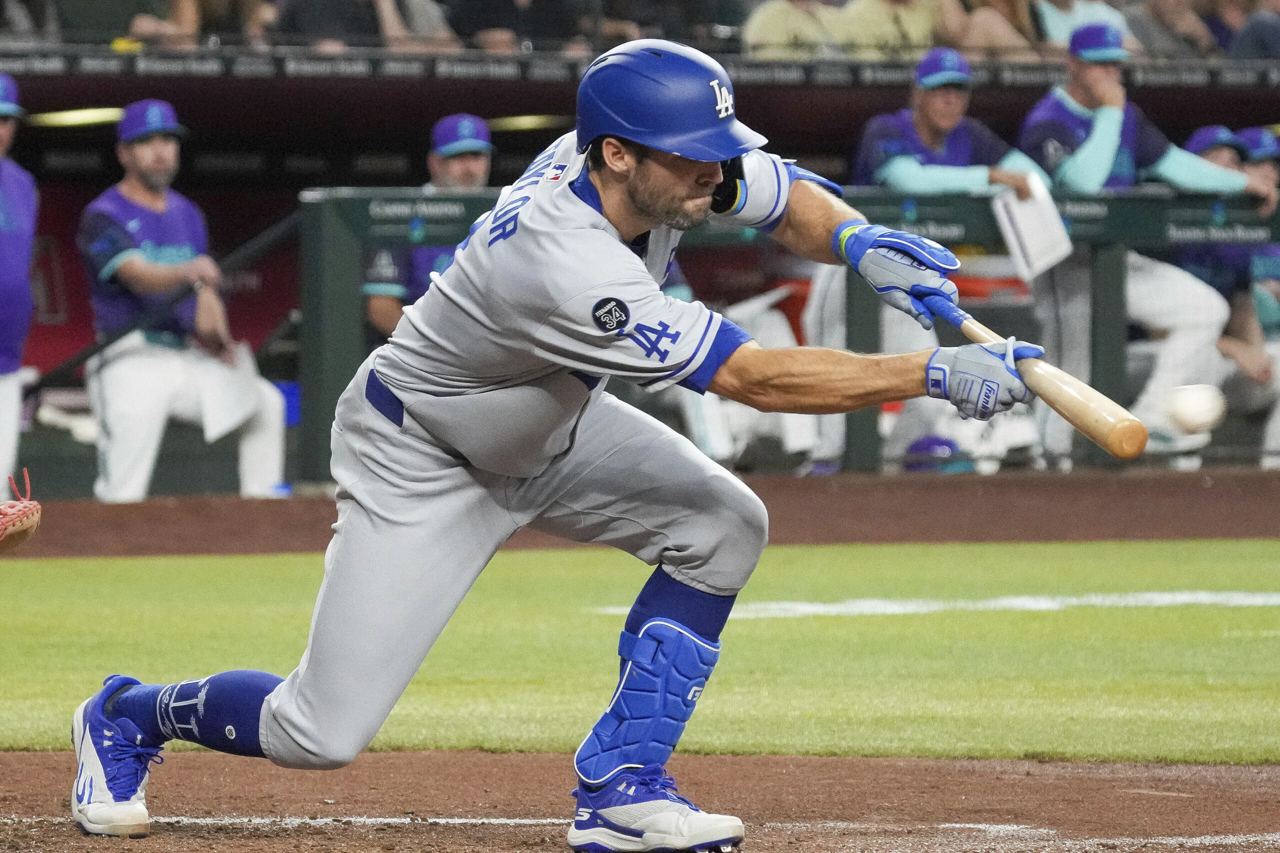 The Dodgers Chris Taylor lays down a bunt against the...