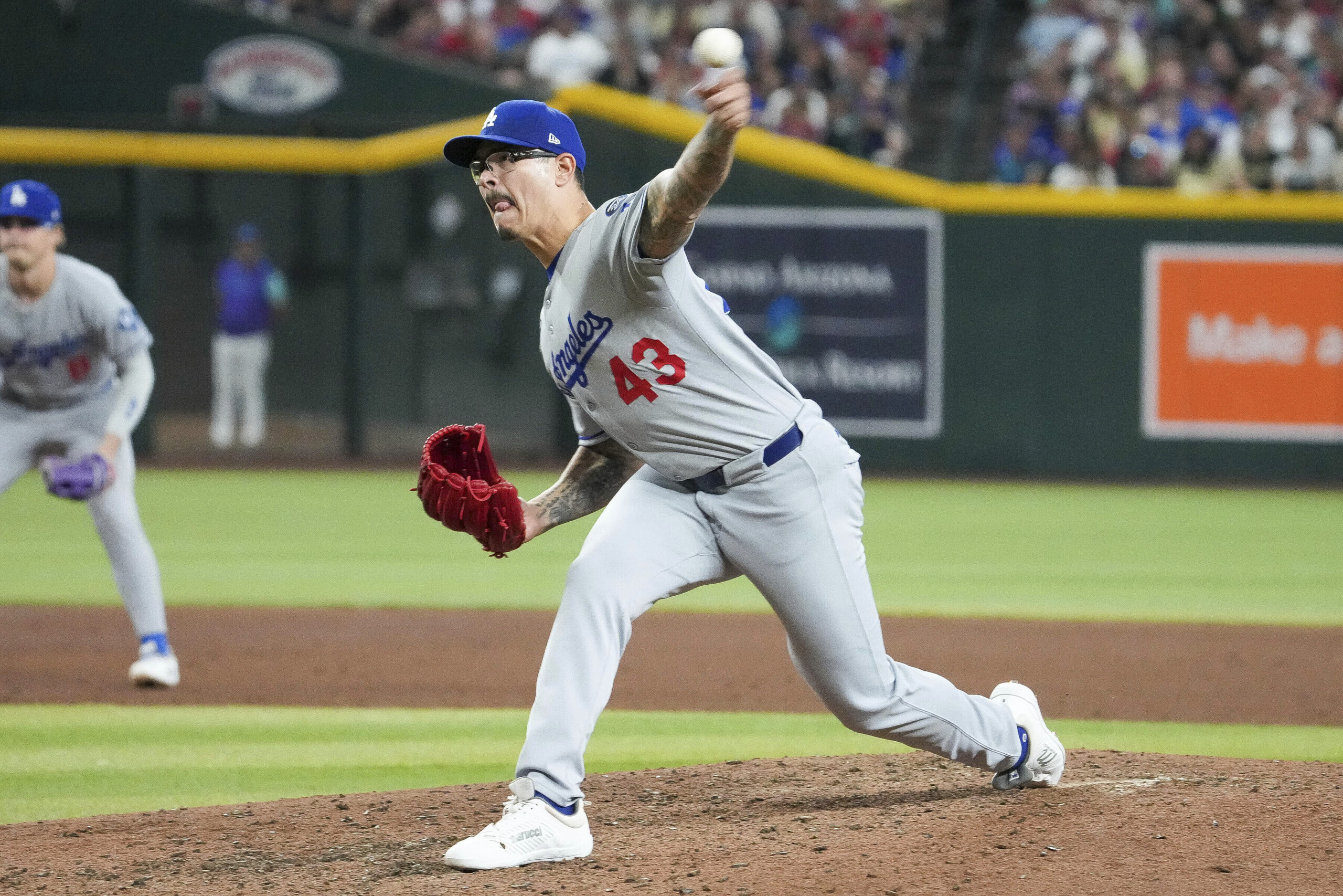 Dodgers relief pitcher Anthony Banda throws to the plate against...
