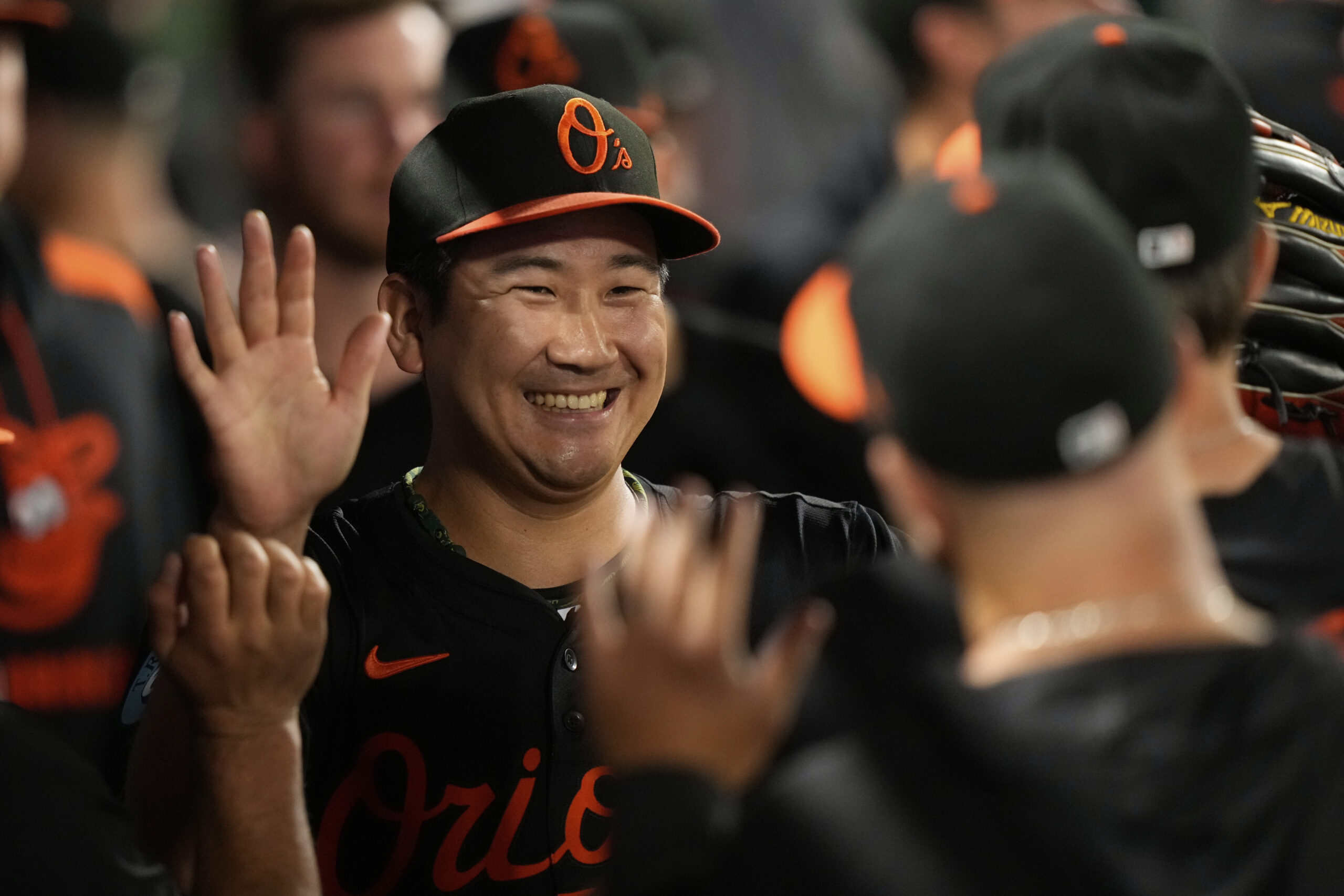 Baltimore Orioles starting pitcher Tomoyuki Sugano is congratulated by teammates...