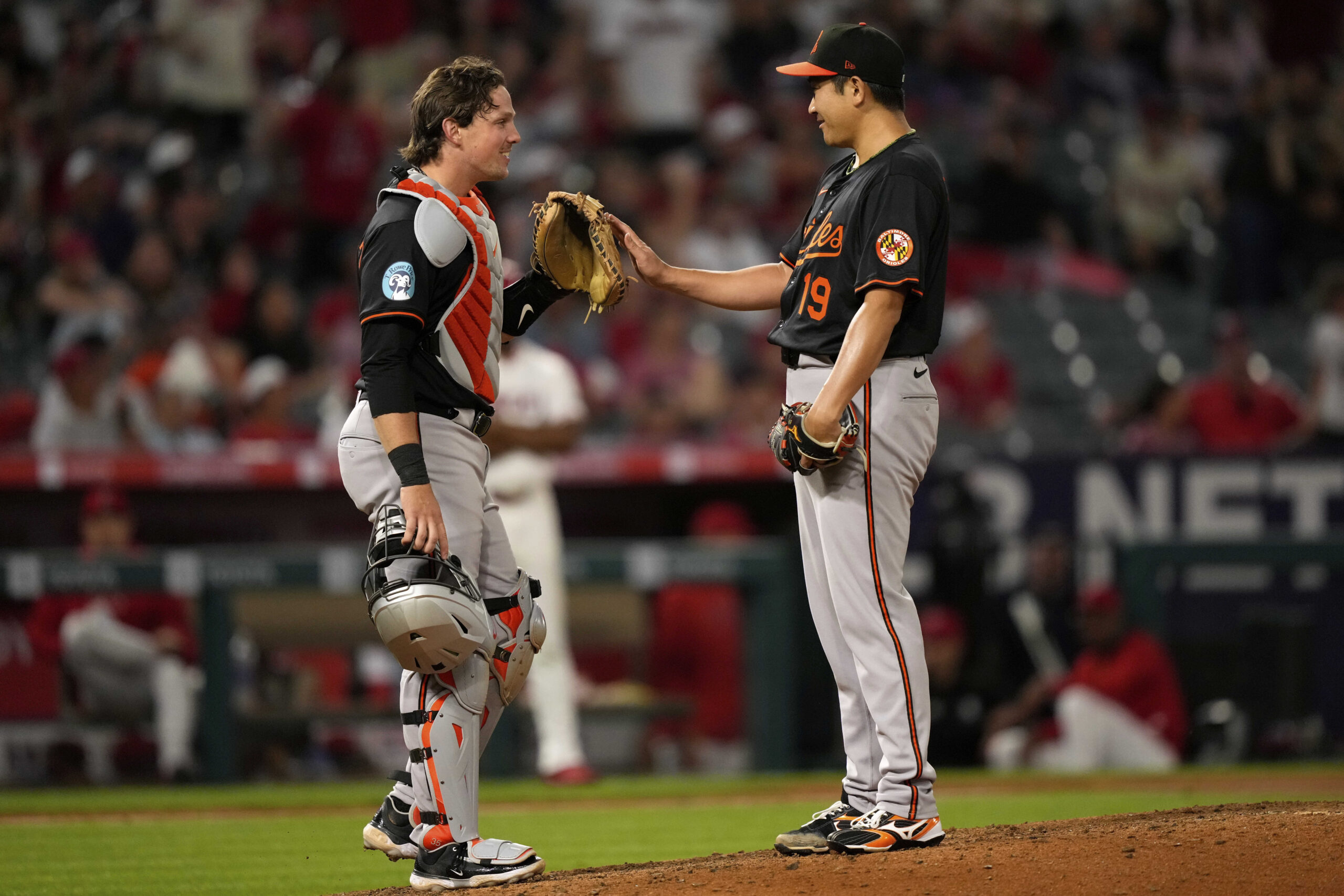 Baltimore Orioles starting pitcher Tomoyuki Sugano, right, is congratulated by...
