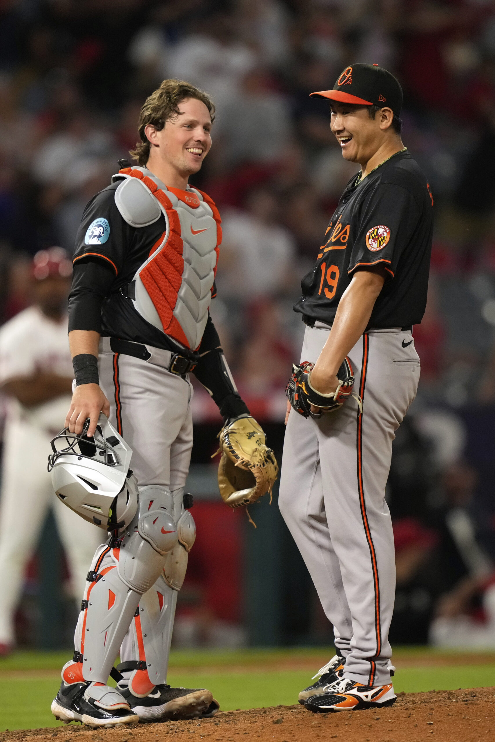 Baltimore Orioles starting pitcher Tomoyuki Sugano, right, talks with catcher...