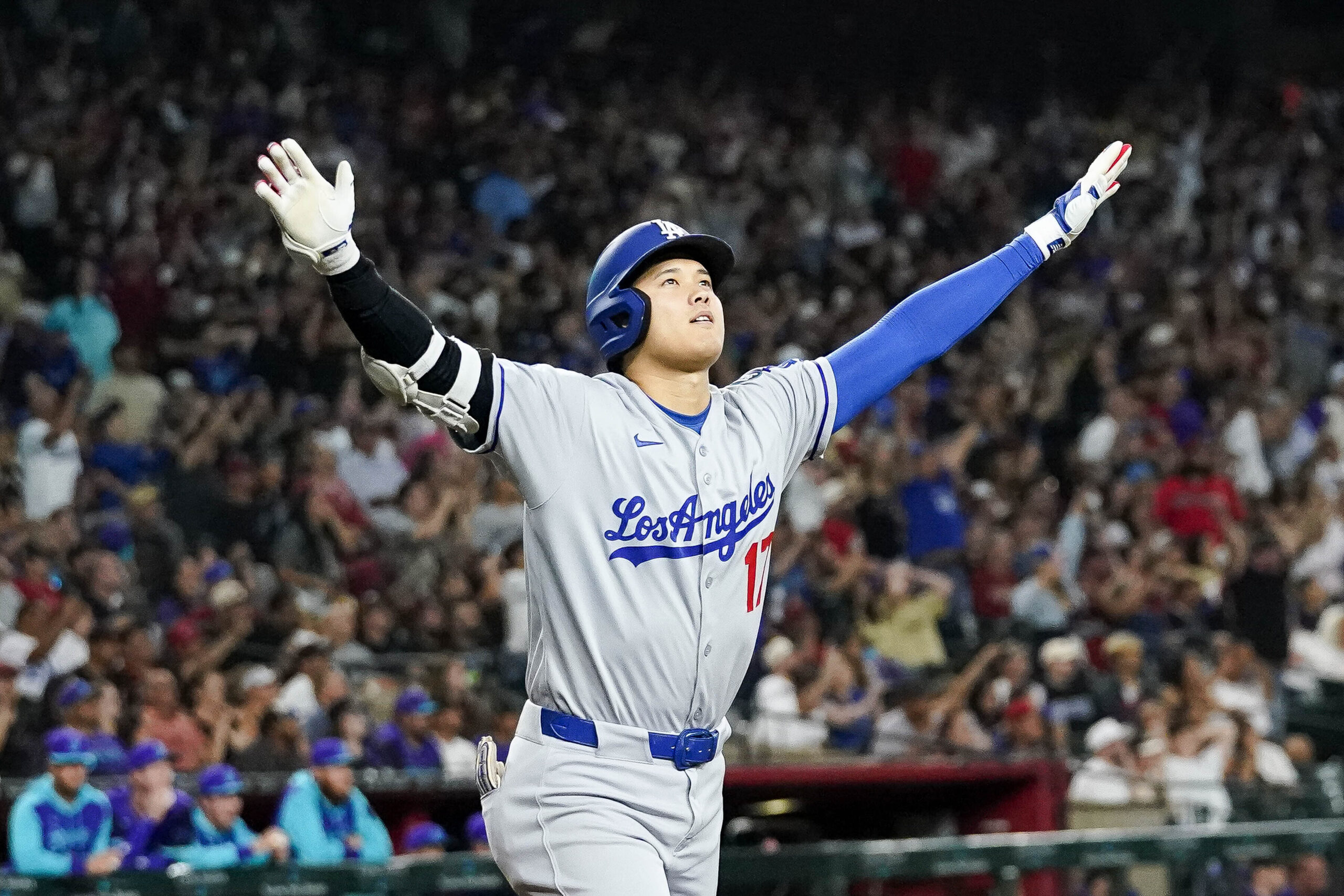 Dodgers star Shohei Ohtani begins to celebrate after hitting a...