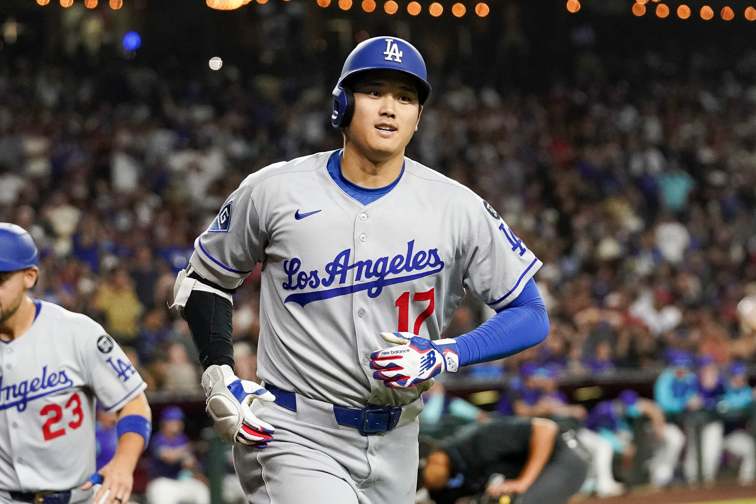 Dodgers star Shohei Ohtani smiles as he heads back to...