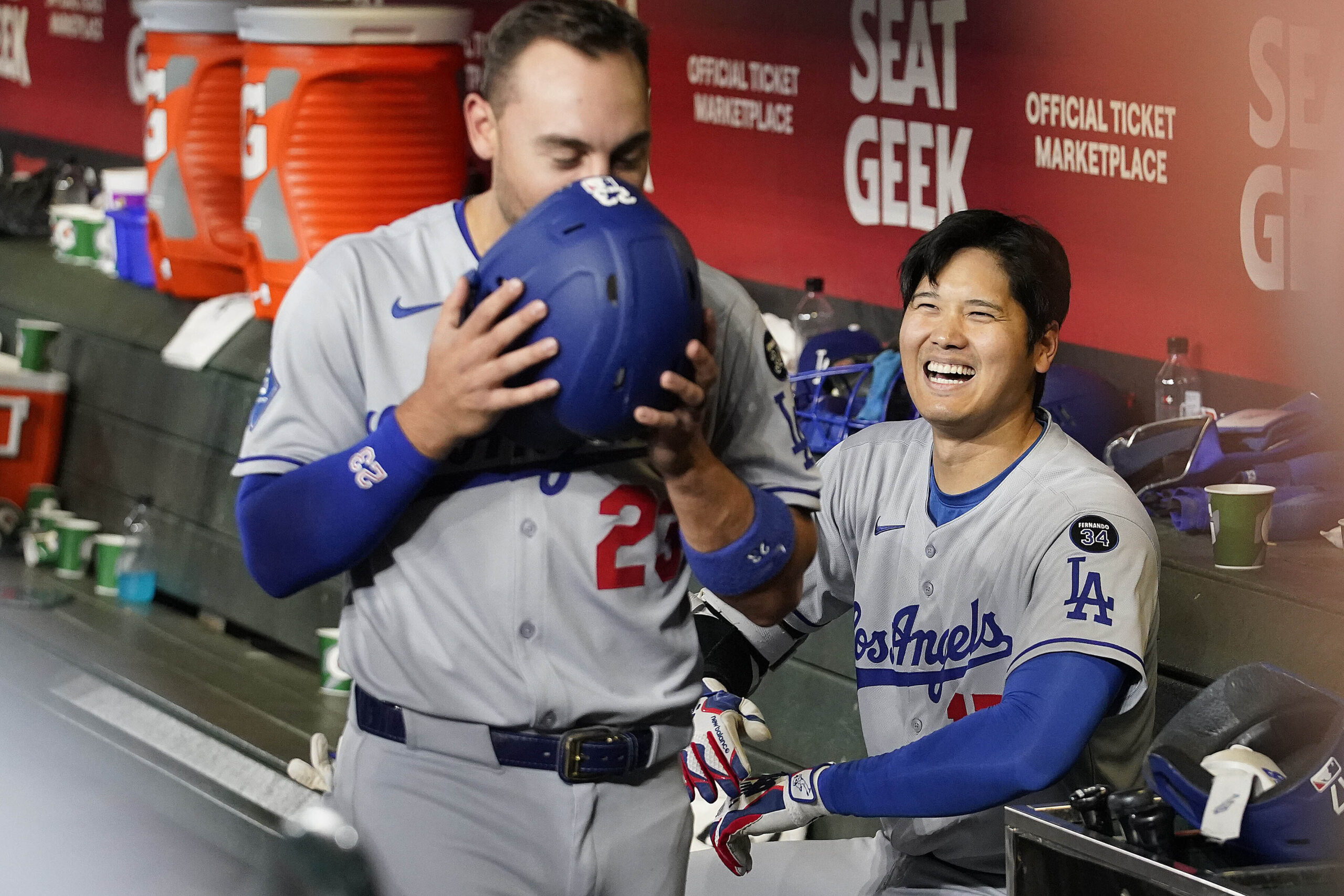 Dodgers star Shohei Ohtani, right, celebrates with teammate Michael Conforto...