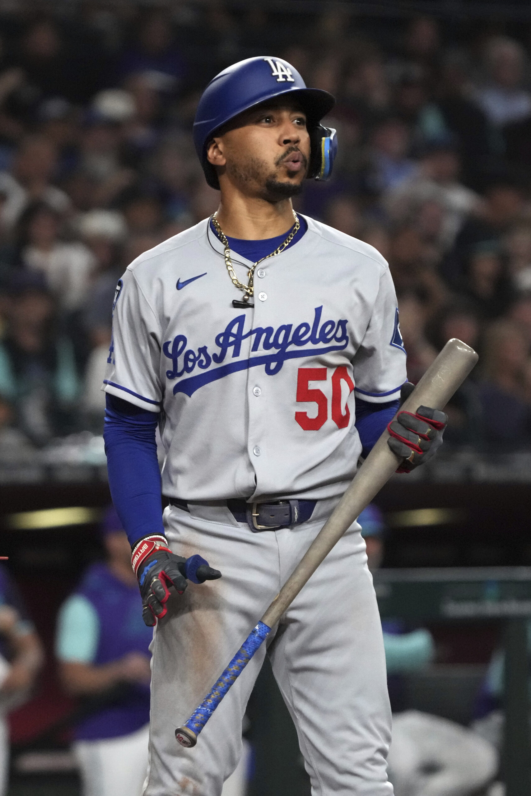 Dodgers’ Mookie Betts reacts after getting called out on strikes...