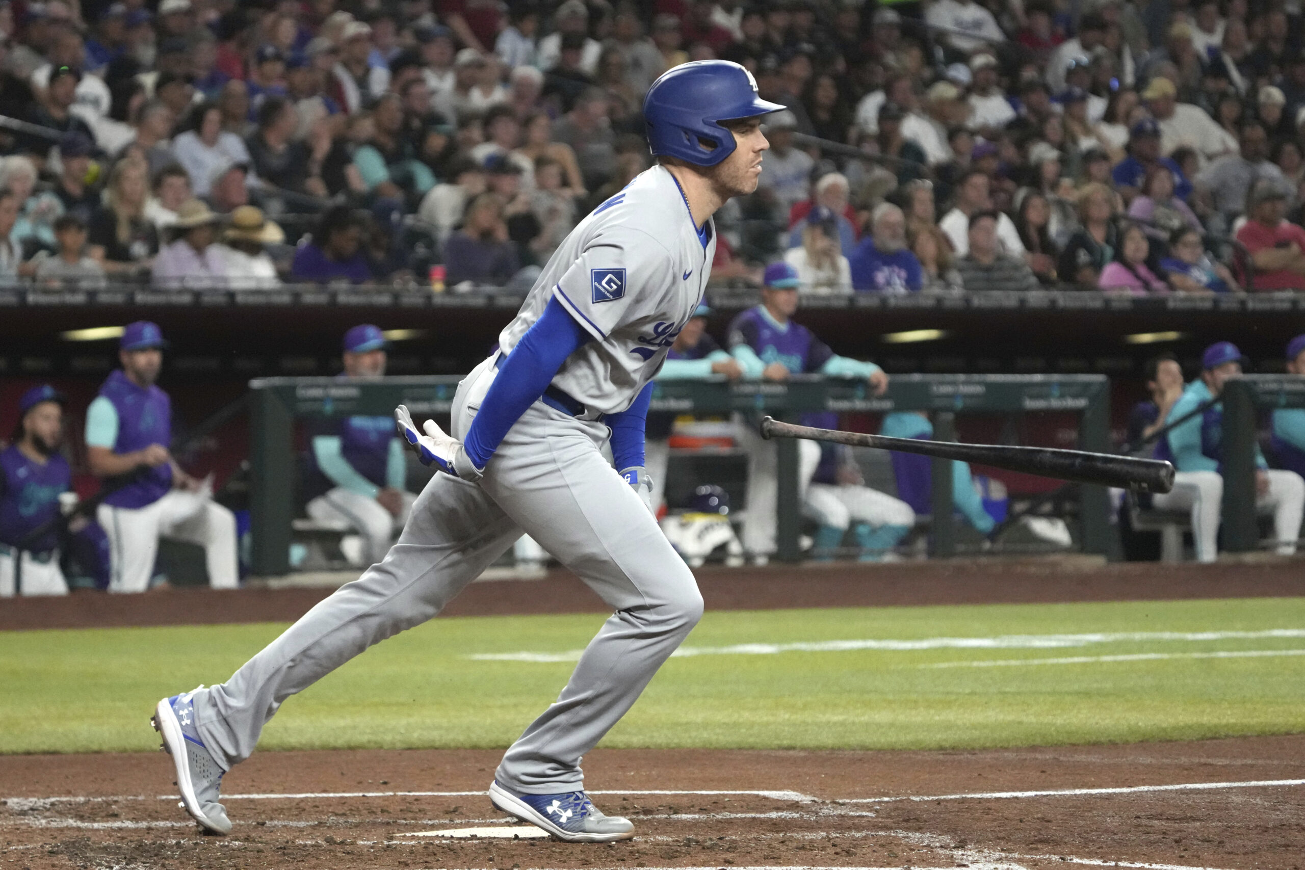 Dodgers’ Freddie Freeman loses his bat after grounding out against...