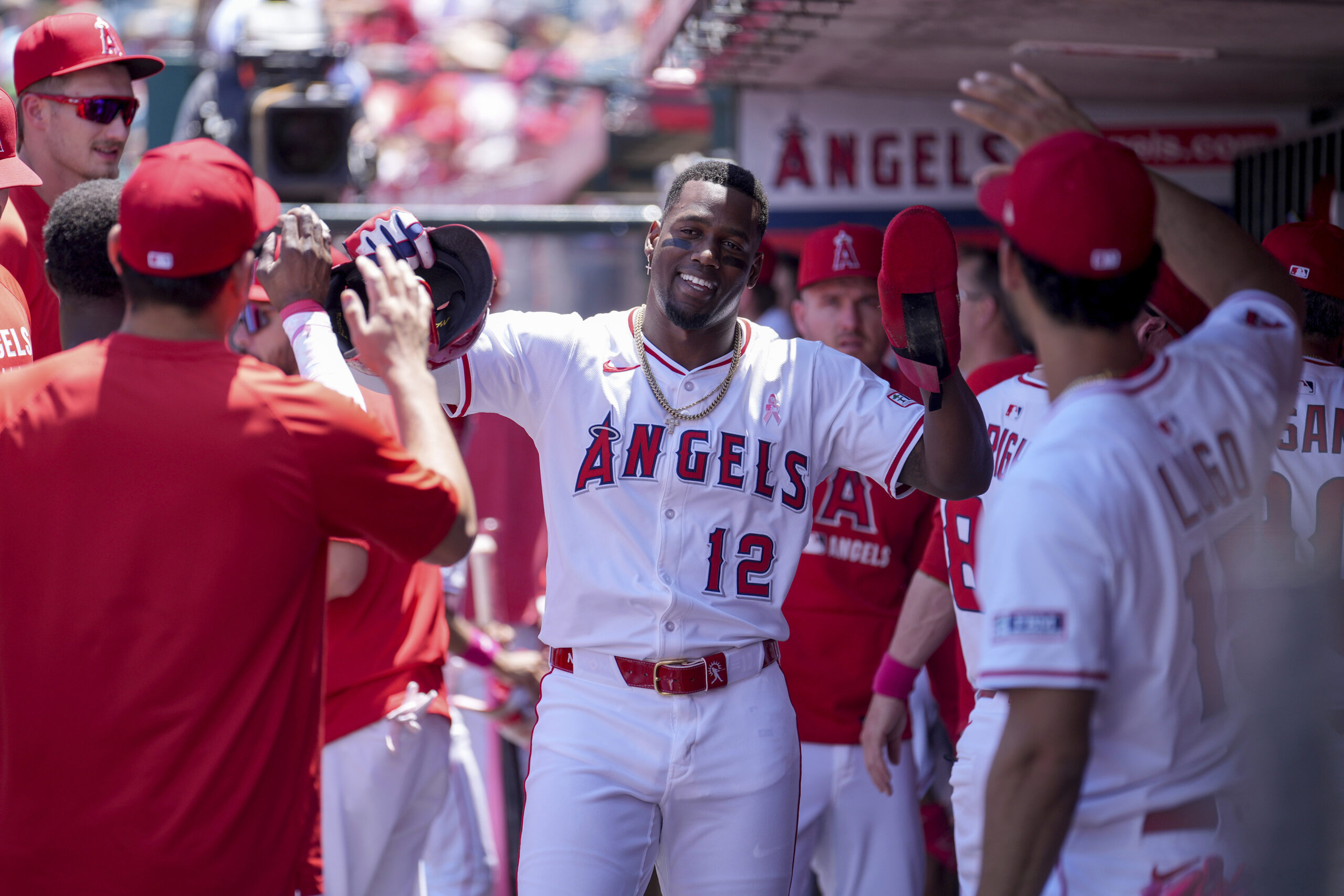 Angels’ Jorge Soler (12) high fives teammates after scoring during...