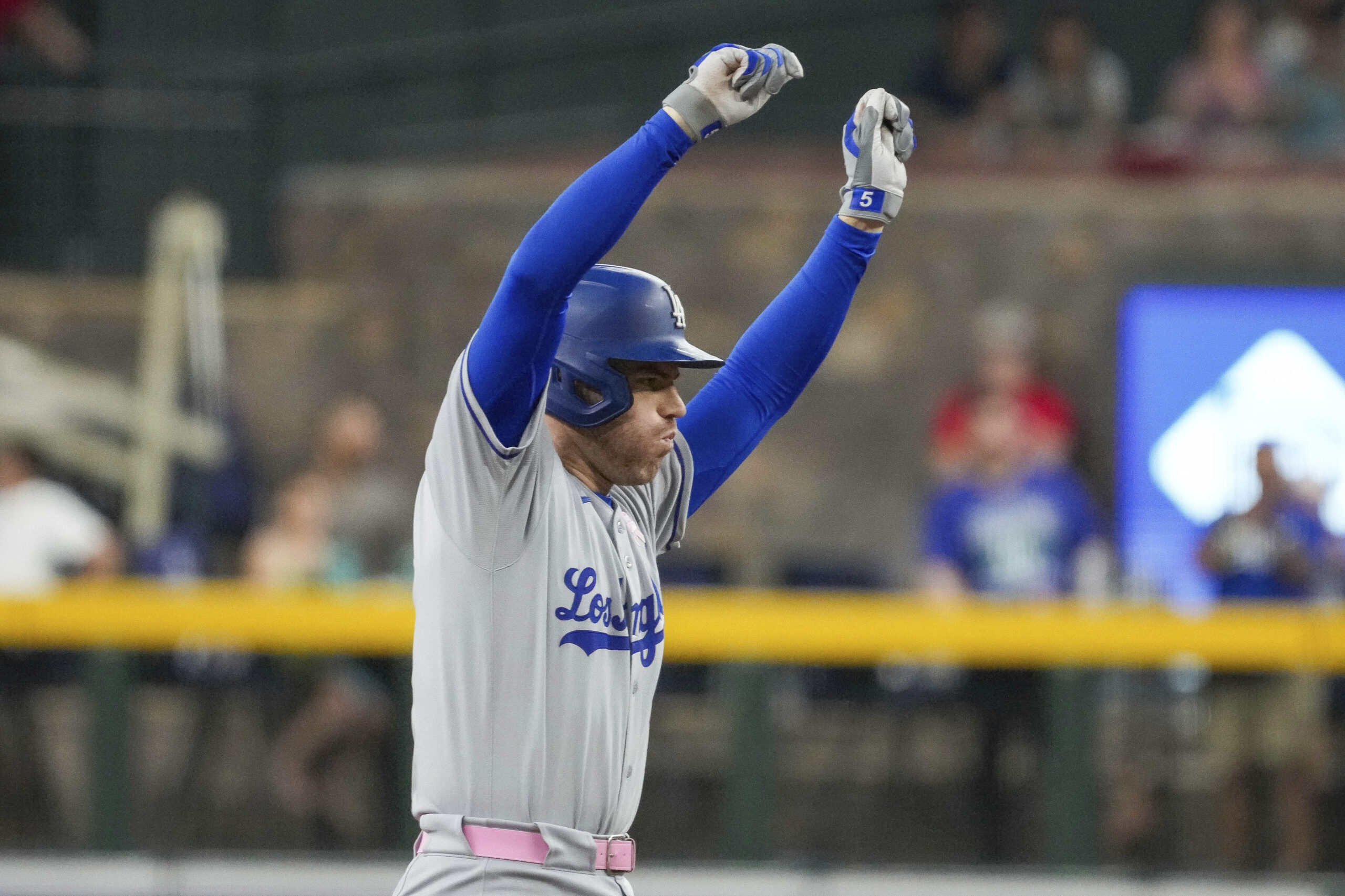 Dodgers’ Freddie Freeman celebrates after hitting a double while scoring...