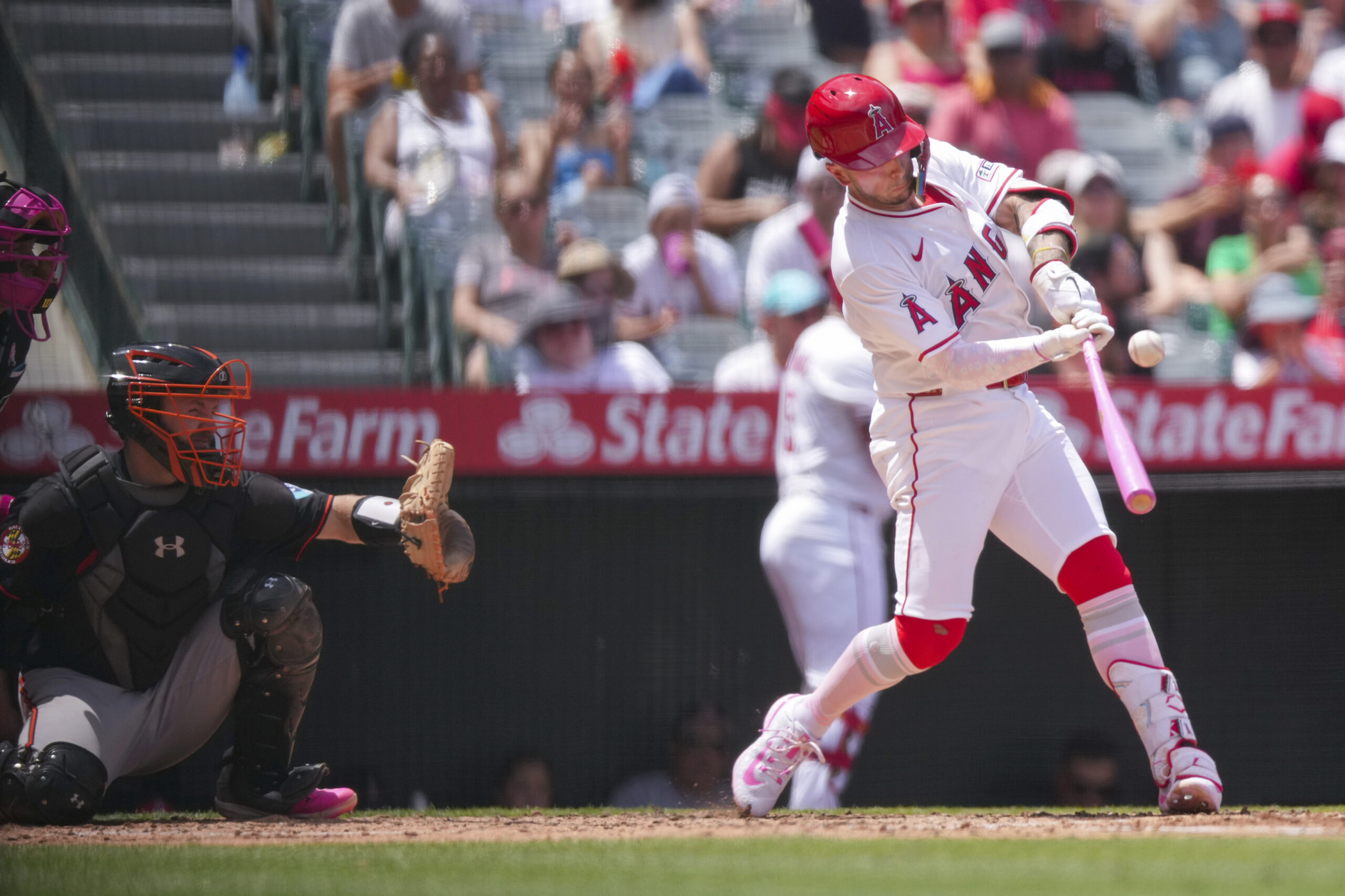 Angels’ Zach Neto makes contact with the ball during the...