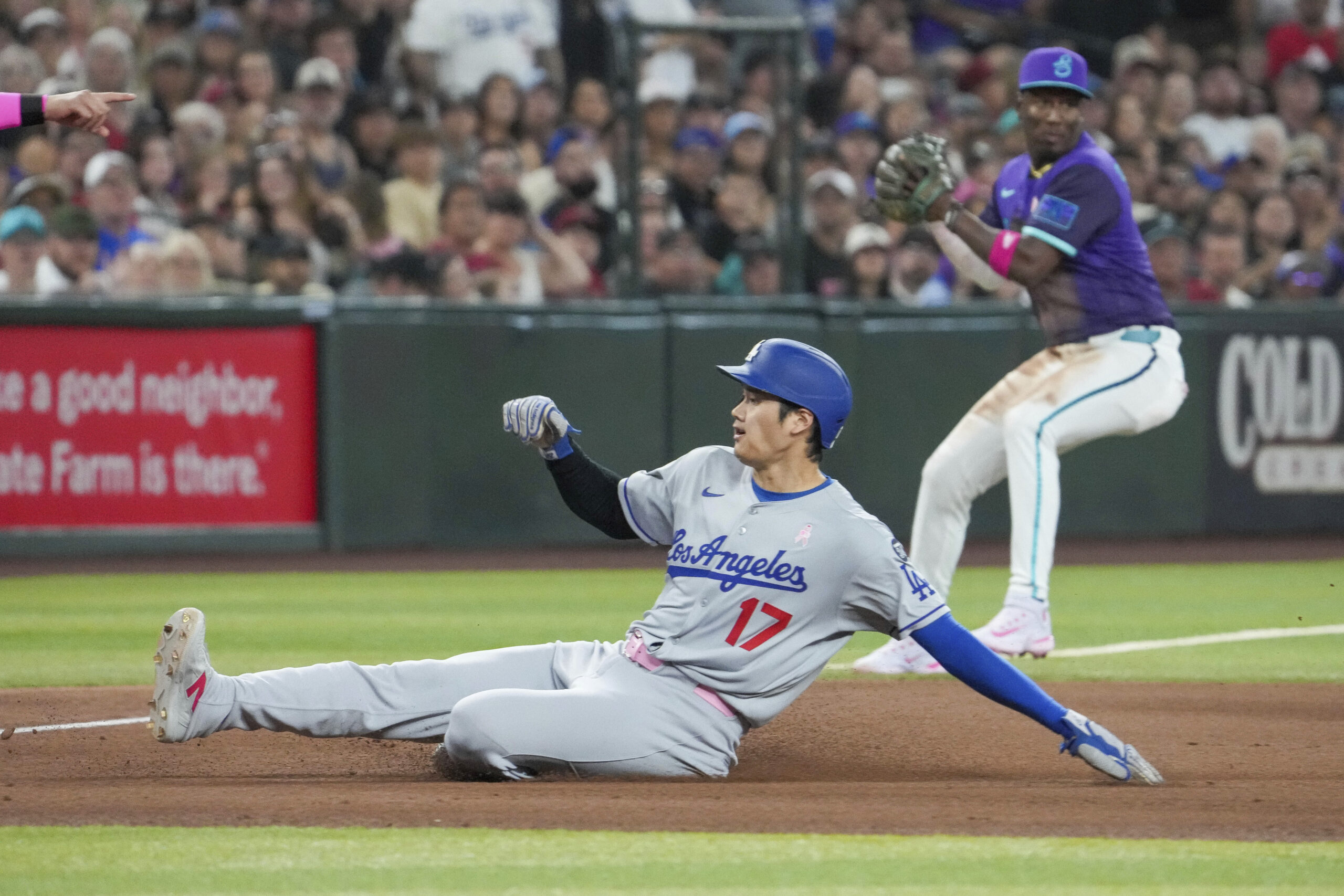Dodgers’ Shohei Ohtani (17) slides safely into third base in...