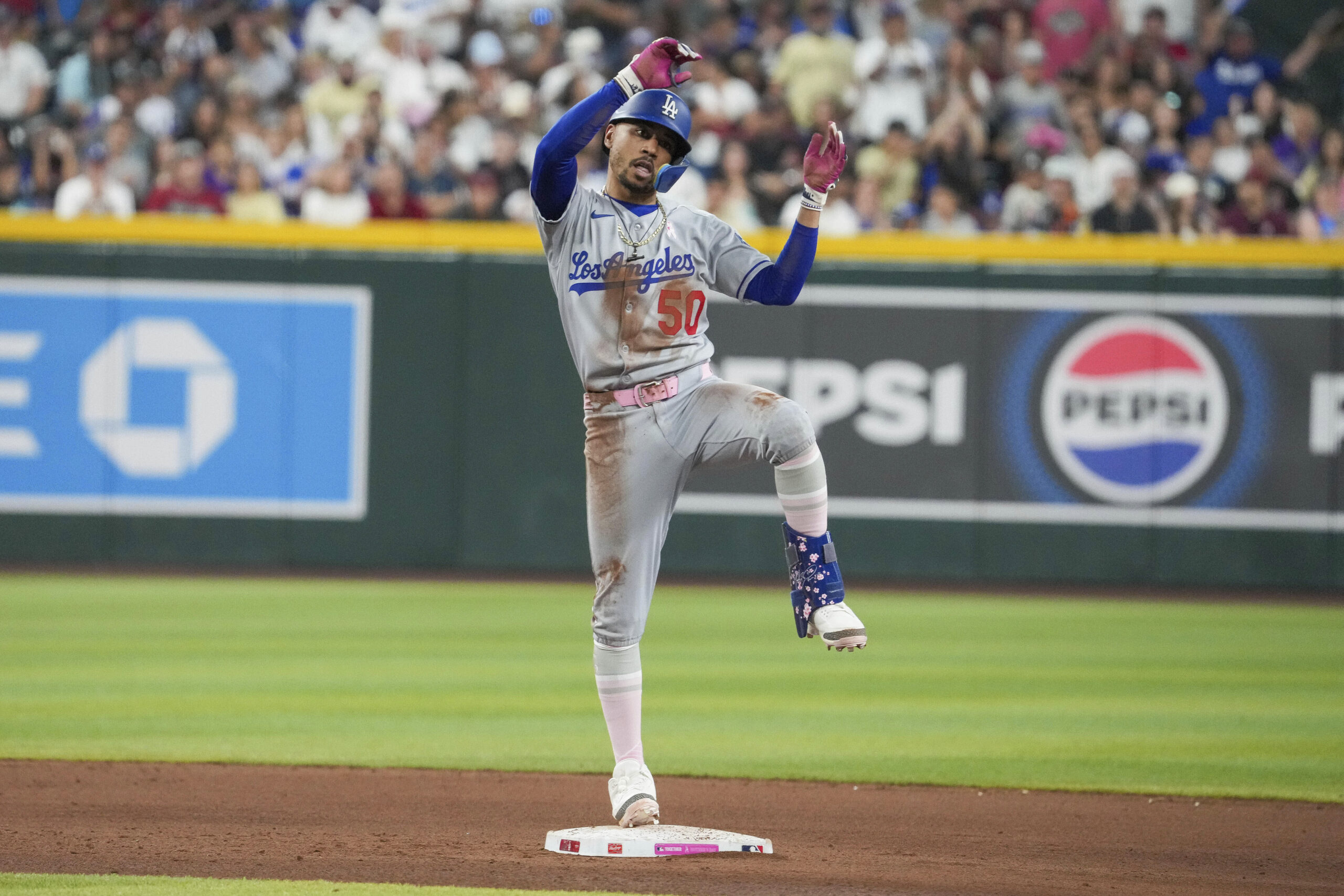 Dodgers’ Mookie Betts celebrates after hitting a double against the...