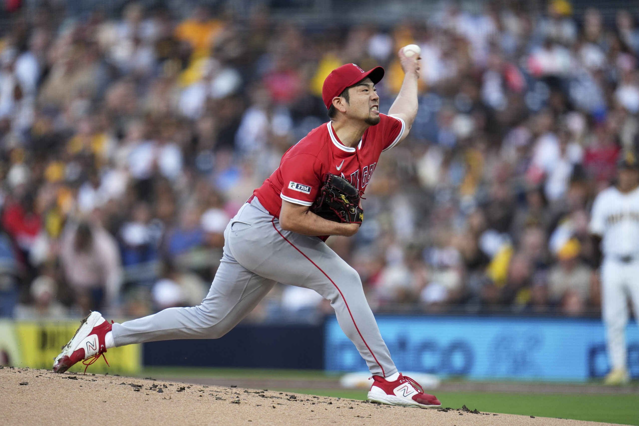 Angels starting pitcher Yusei Kikuchi throws to the plate during...