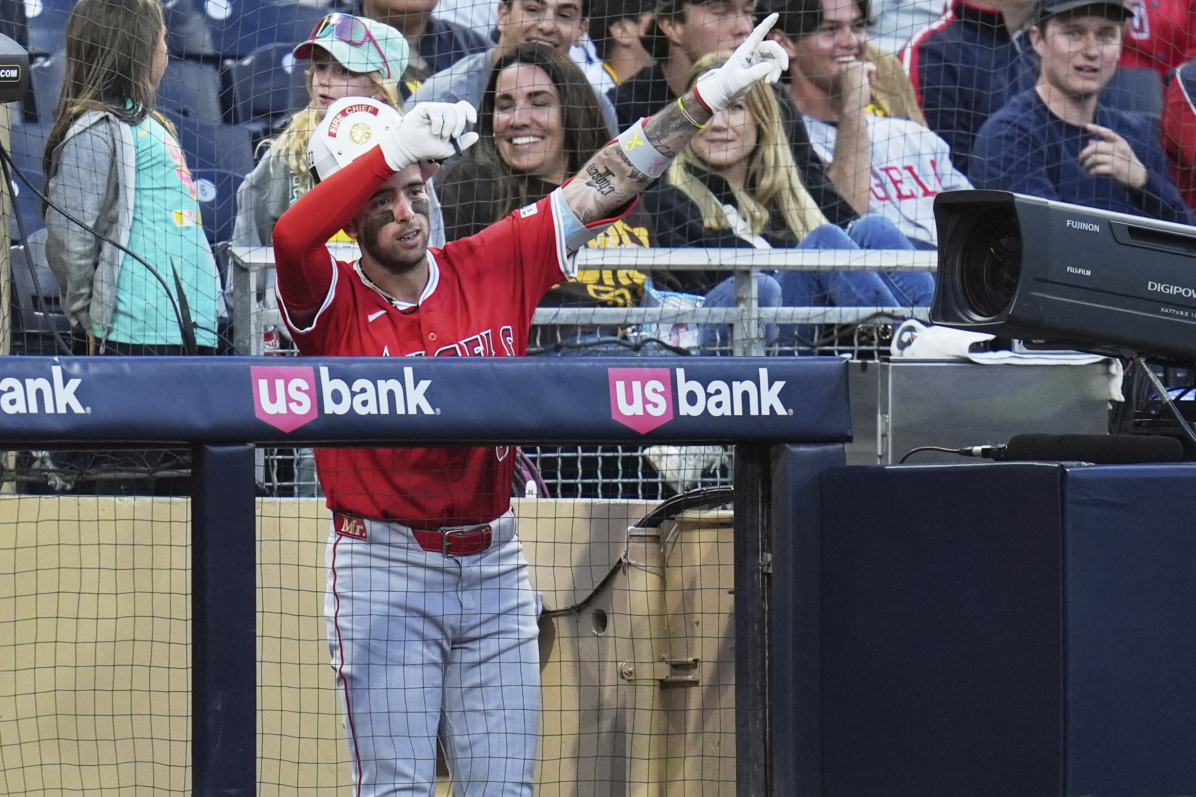 The Angels’ Zach Neto celebrates in the dugout after hitting...