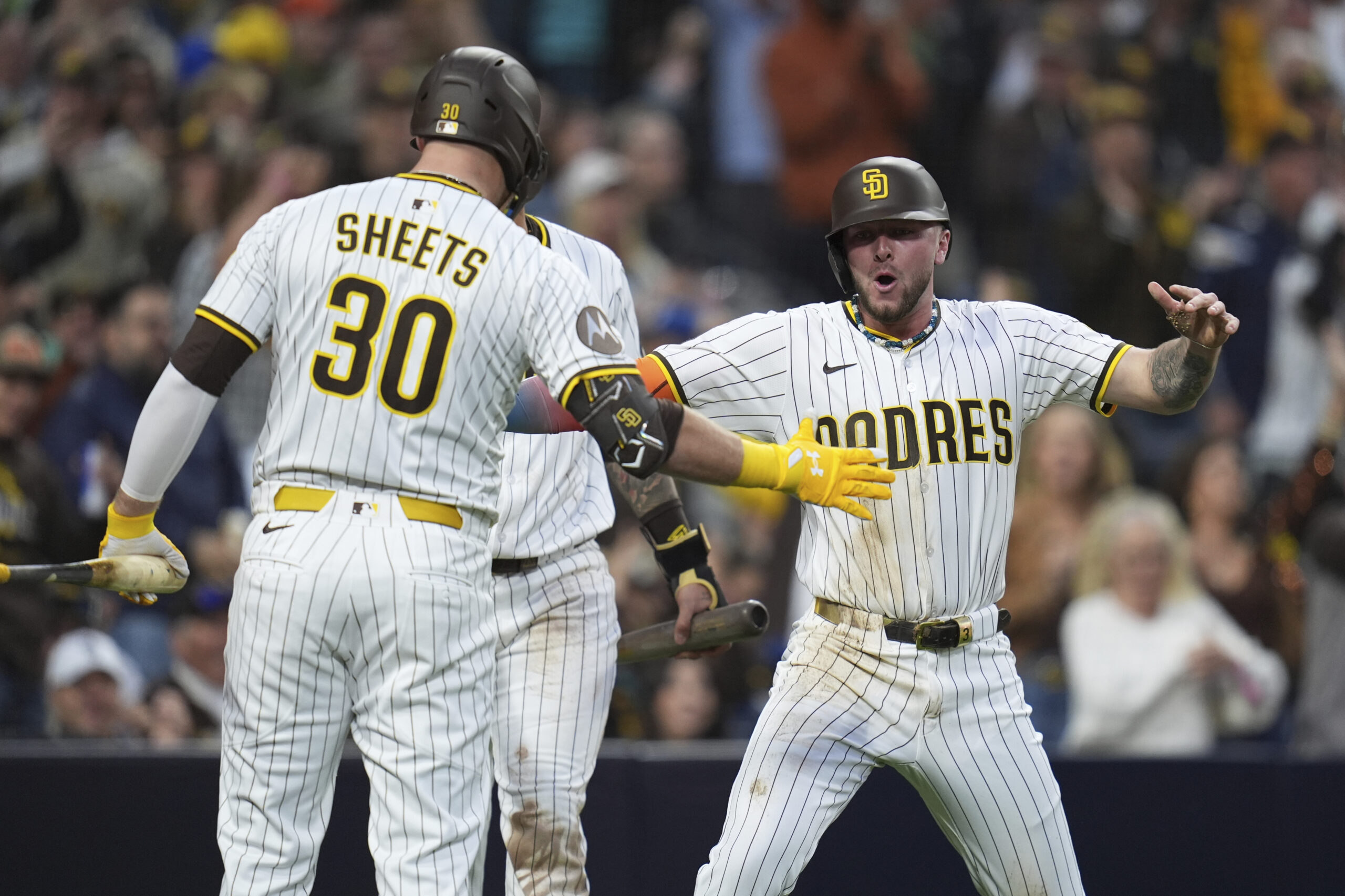 The San Diego Padres’ Jackson Merrill, right, celebrates with teammate...