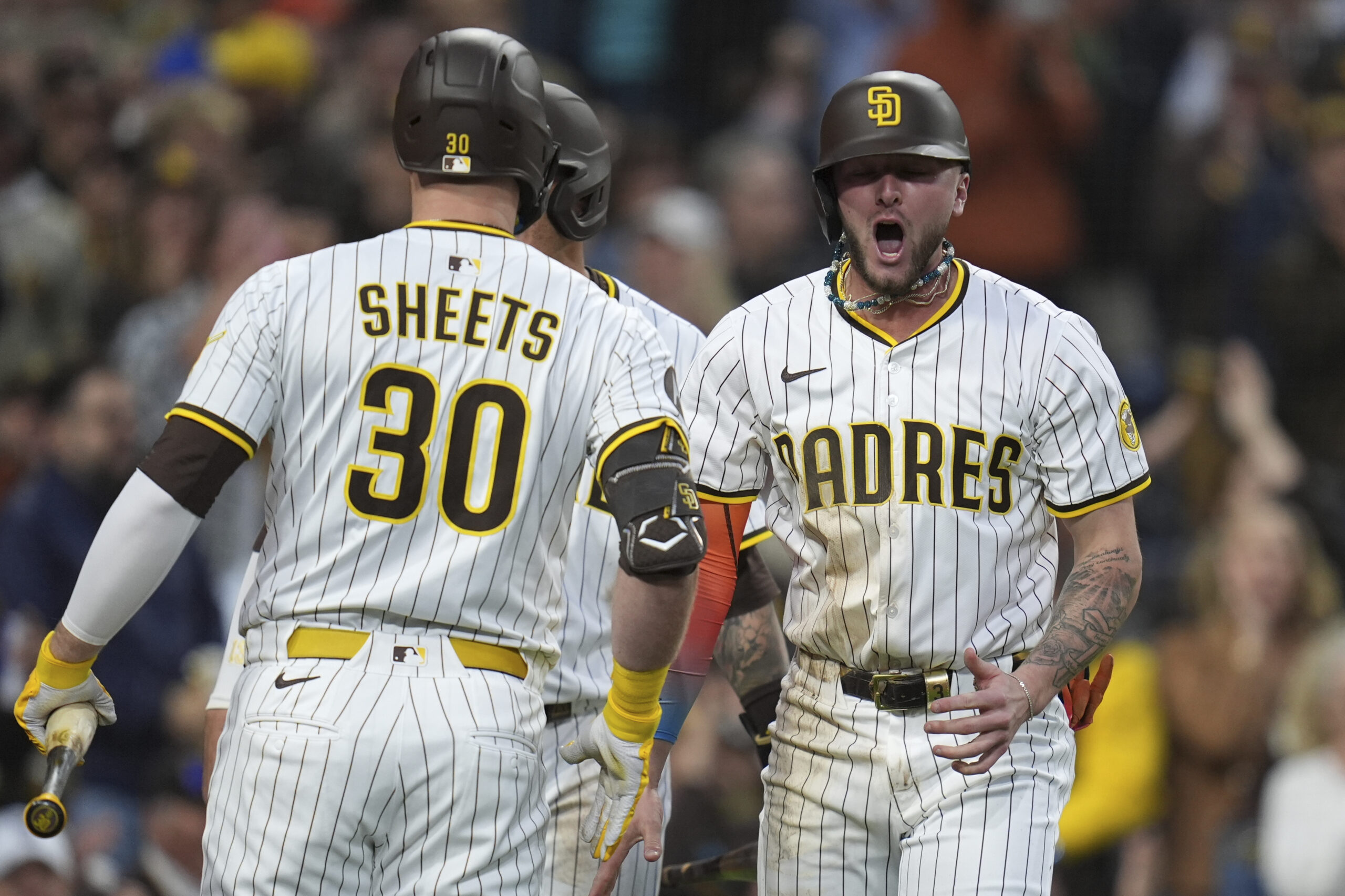 The San Diego Padres’ Jackson Merrill, right, celebrates with teammate...