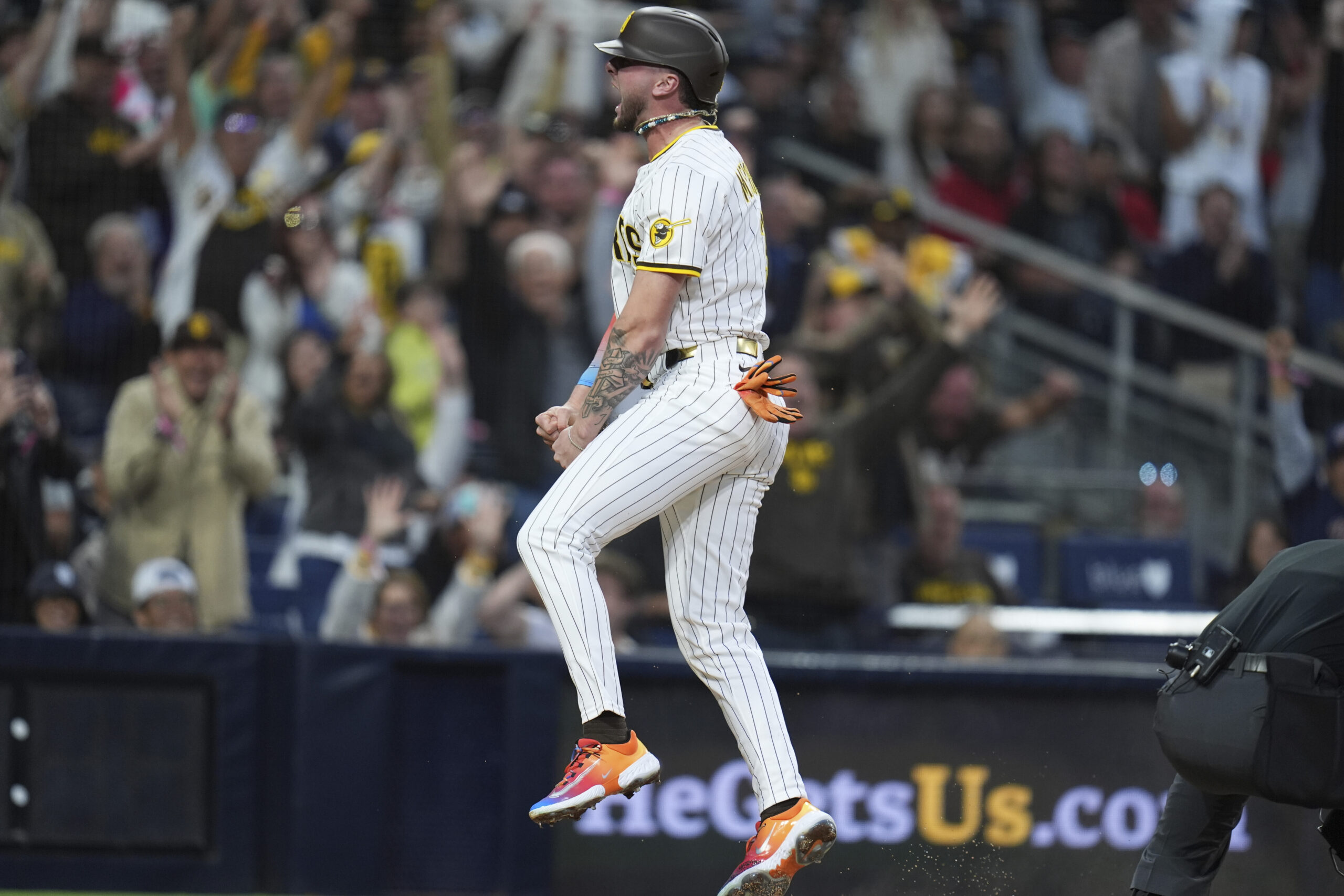 The San Diego Padres’ Jackson Merrill celebrates after scoring on...
