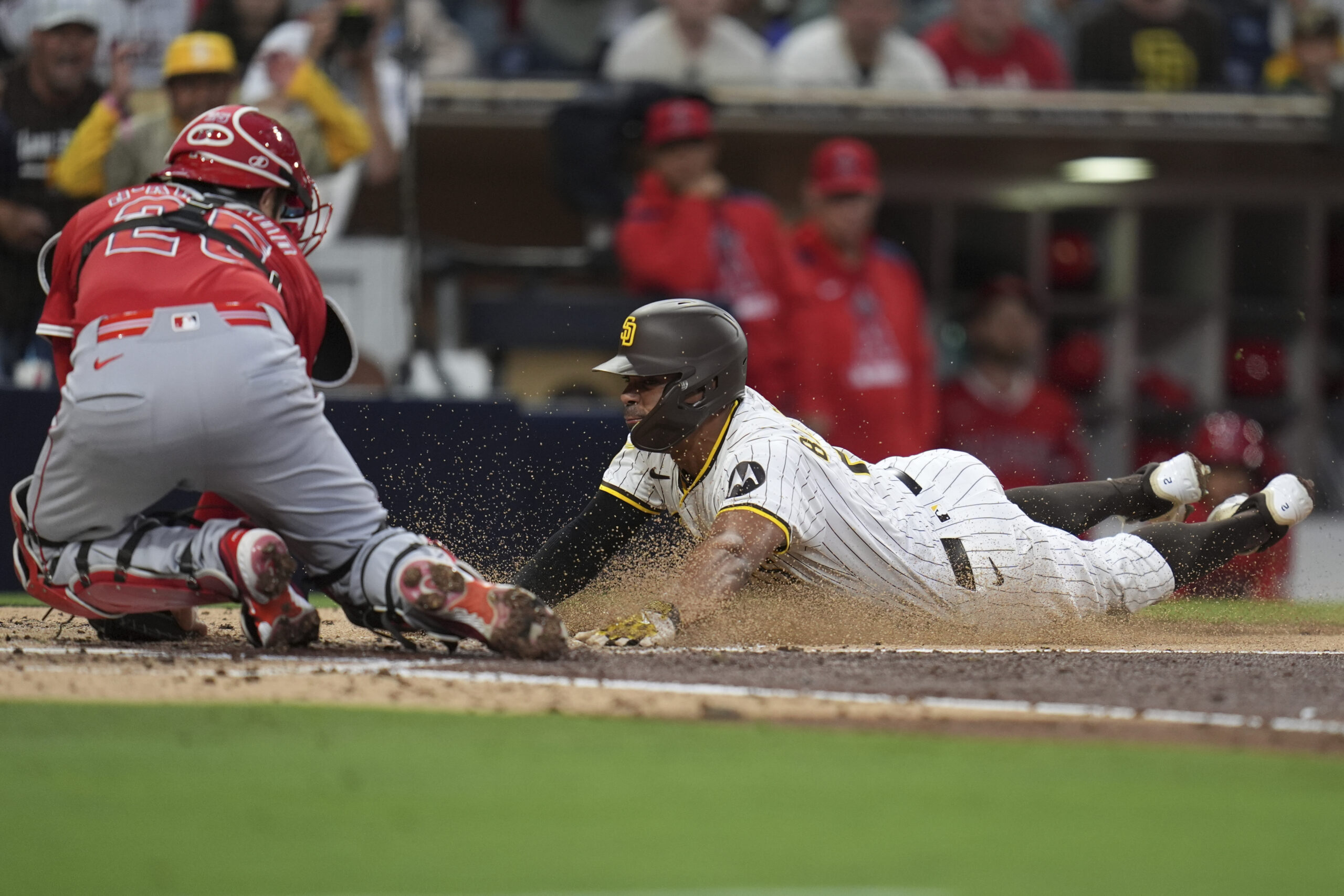 The San Diego Padres’ Xander Bogaerts, right, slides in late...